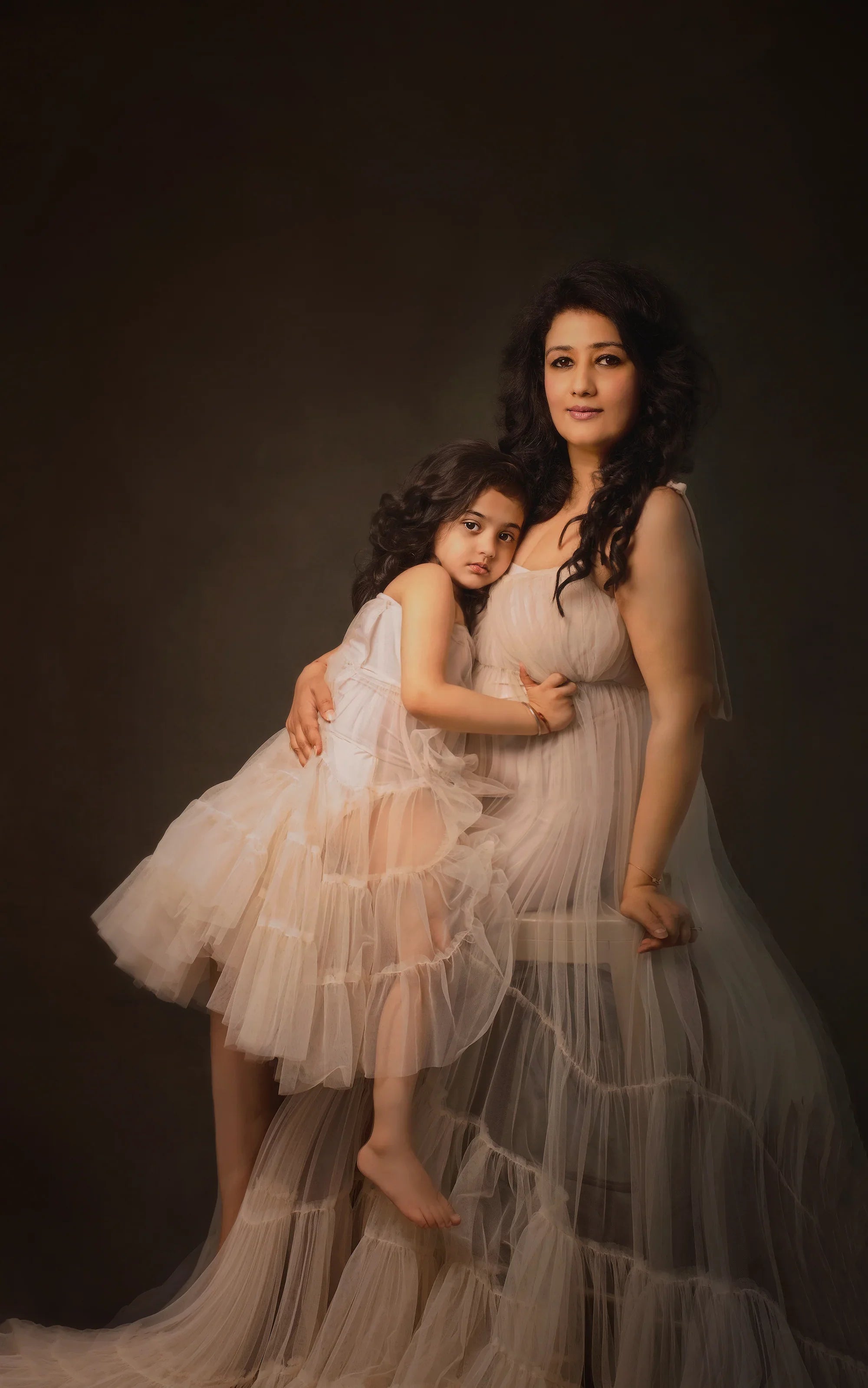 Maternity photoshoot with mother and daughter in matching sheer ruffled gowns