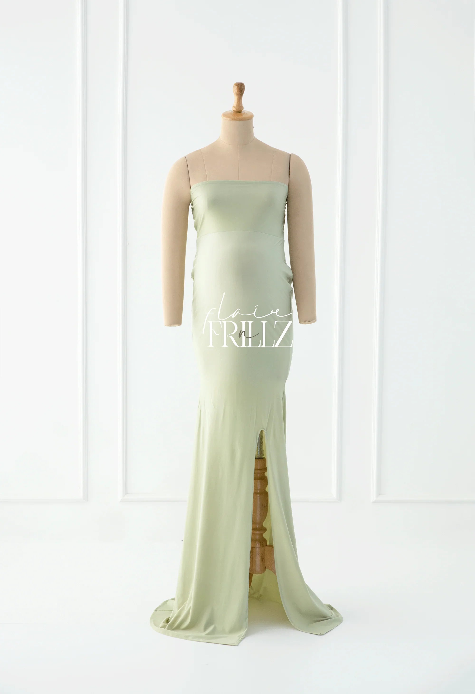 Mint green maternity gown with slit, designed for comfort and style during pregnancy.