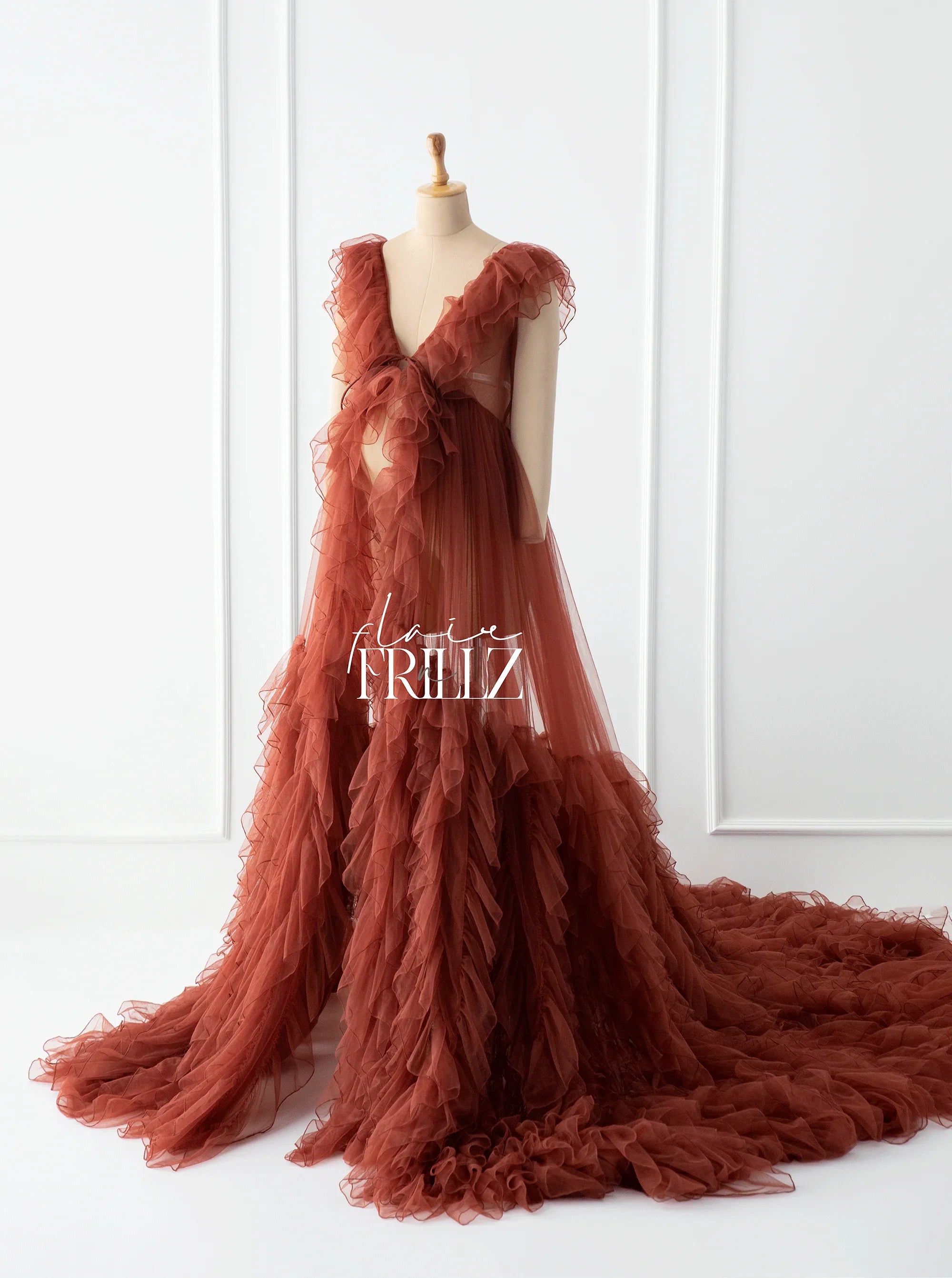 Rust-colored ruffled maternity gown with V-neck and flowing train, perfect for elegant pregnancy style.