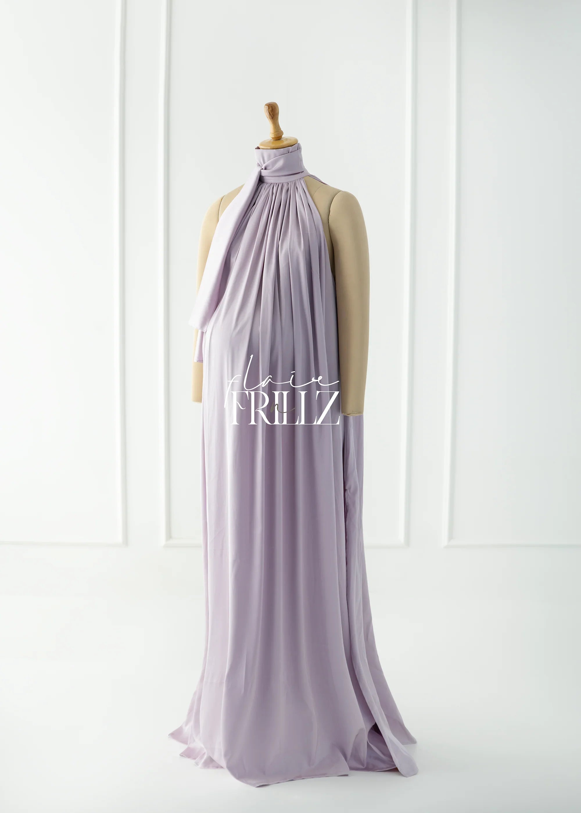 Lavender maternity gown with halter neck and flowy design on mannequin