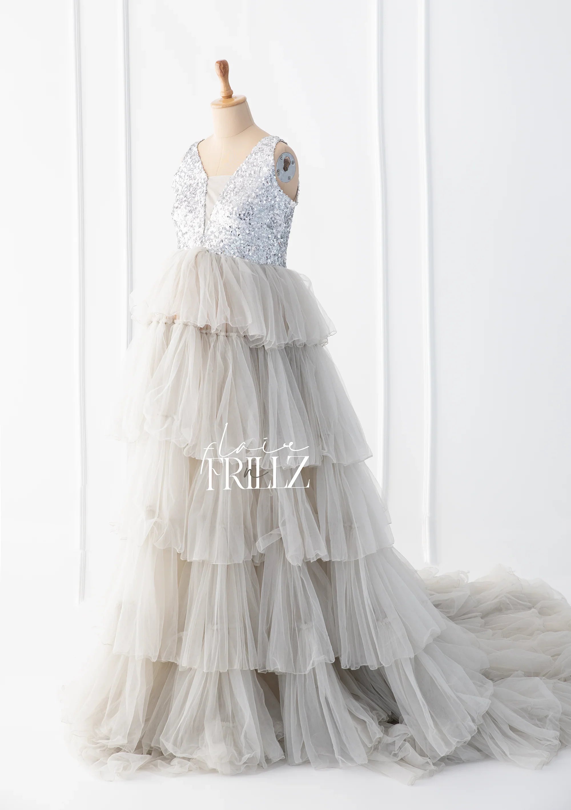 Silver sequin top maternity gown with layered tulle skirt displayed on mannequin