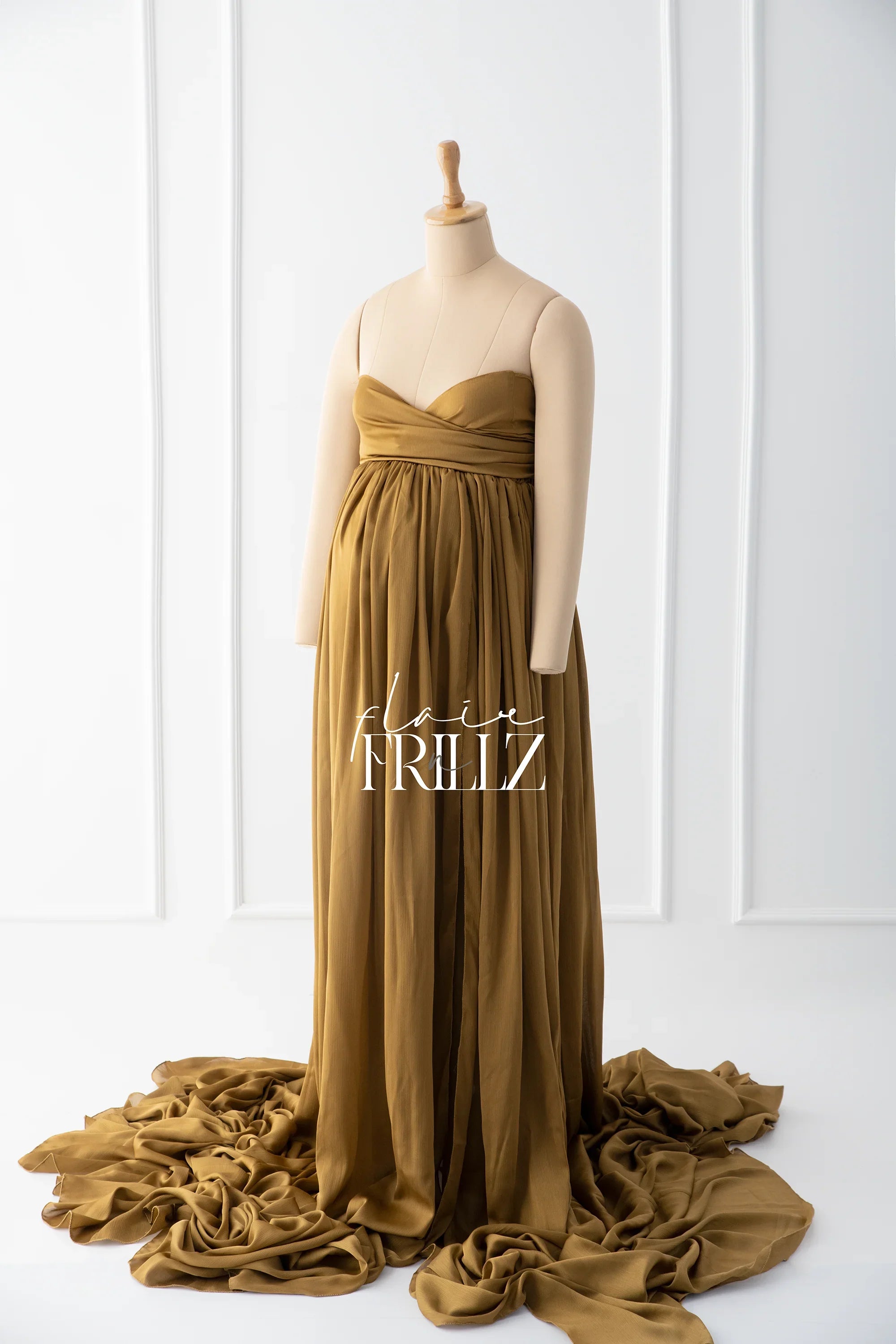 Brown silky maternity gown with sweetheart neckline and flowing train on mannequin