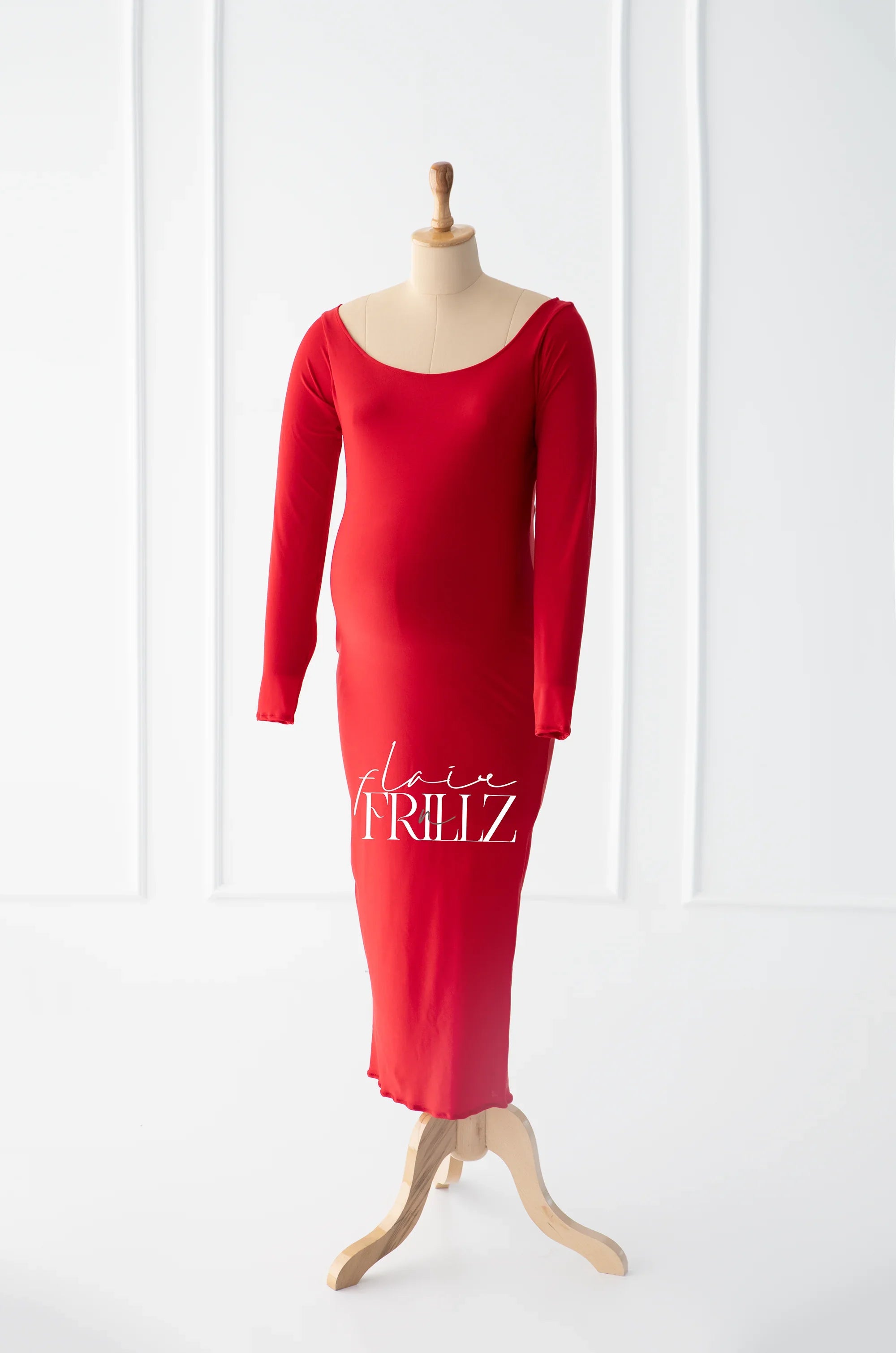 Red long sleeve maternity gown with scoop neckline on mannequin, minimalist background