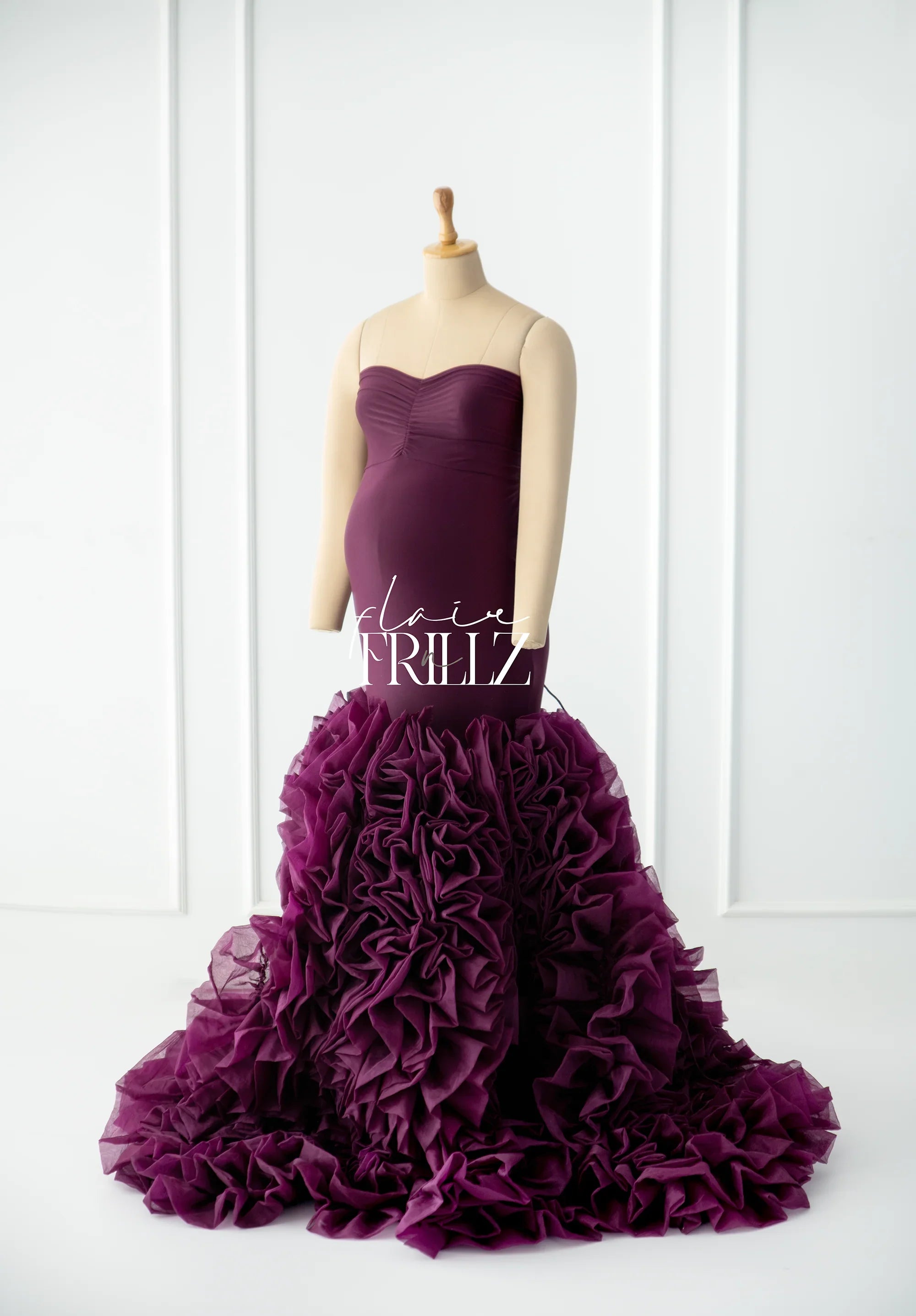 Burgundy strapless fishtail maternity gown with ruffled tulle skirt on mannequin