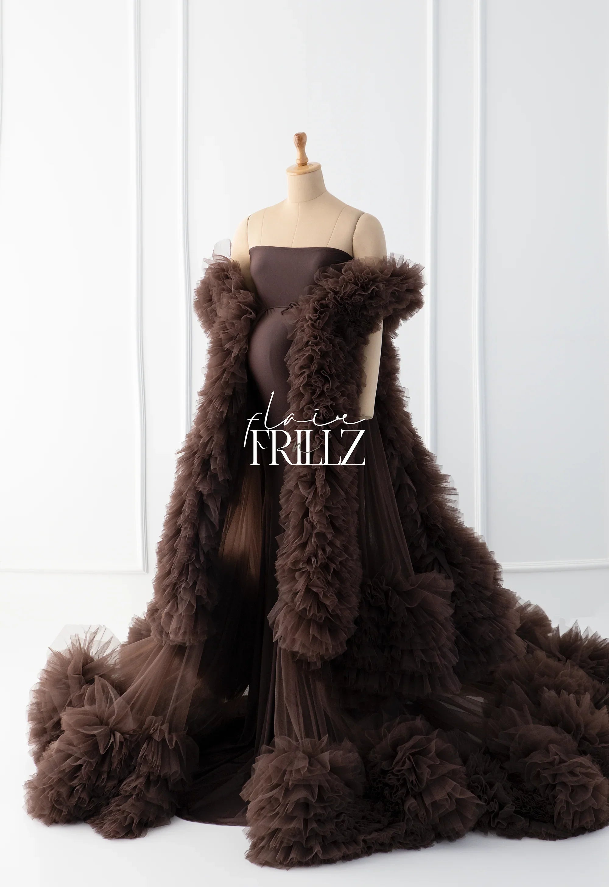 Brown ruffled maternity robe gown on mannequin, strapless with dramatic tulle layers