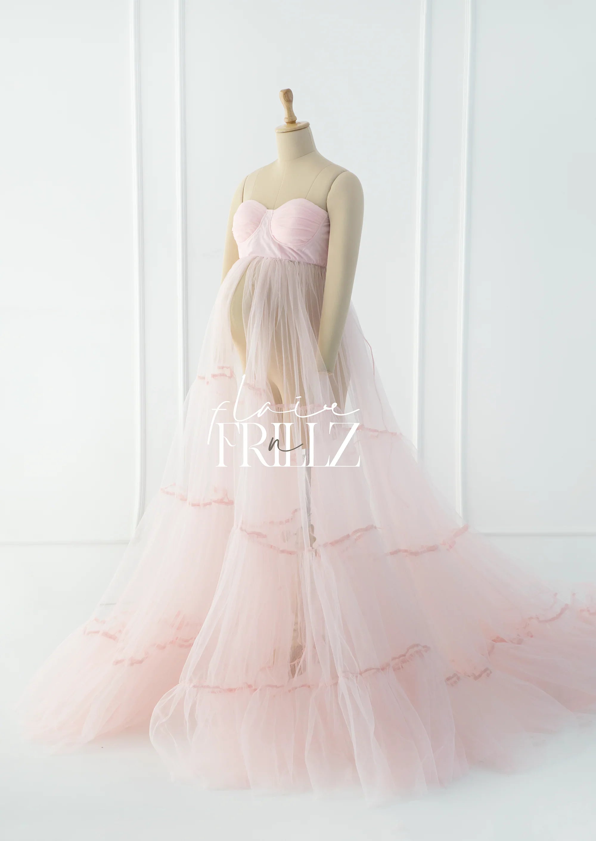 Light pink tulle maternity gown with sweetheart neckline displayed on mannequin