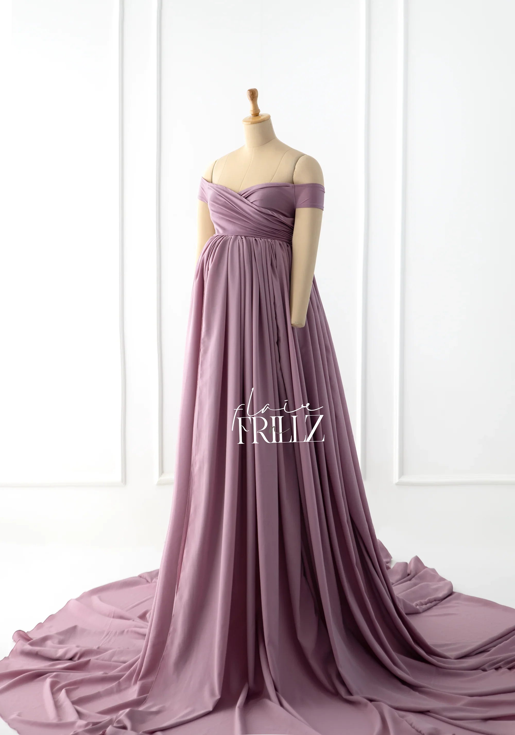 Mauve off-shoulder maternity gown with flowing skirt displayed on mannequin
