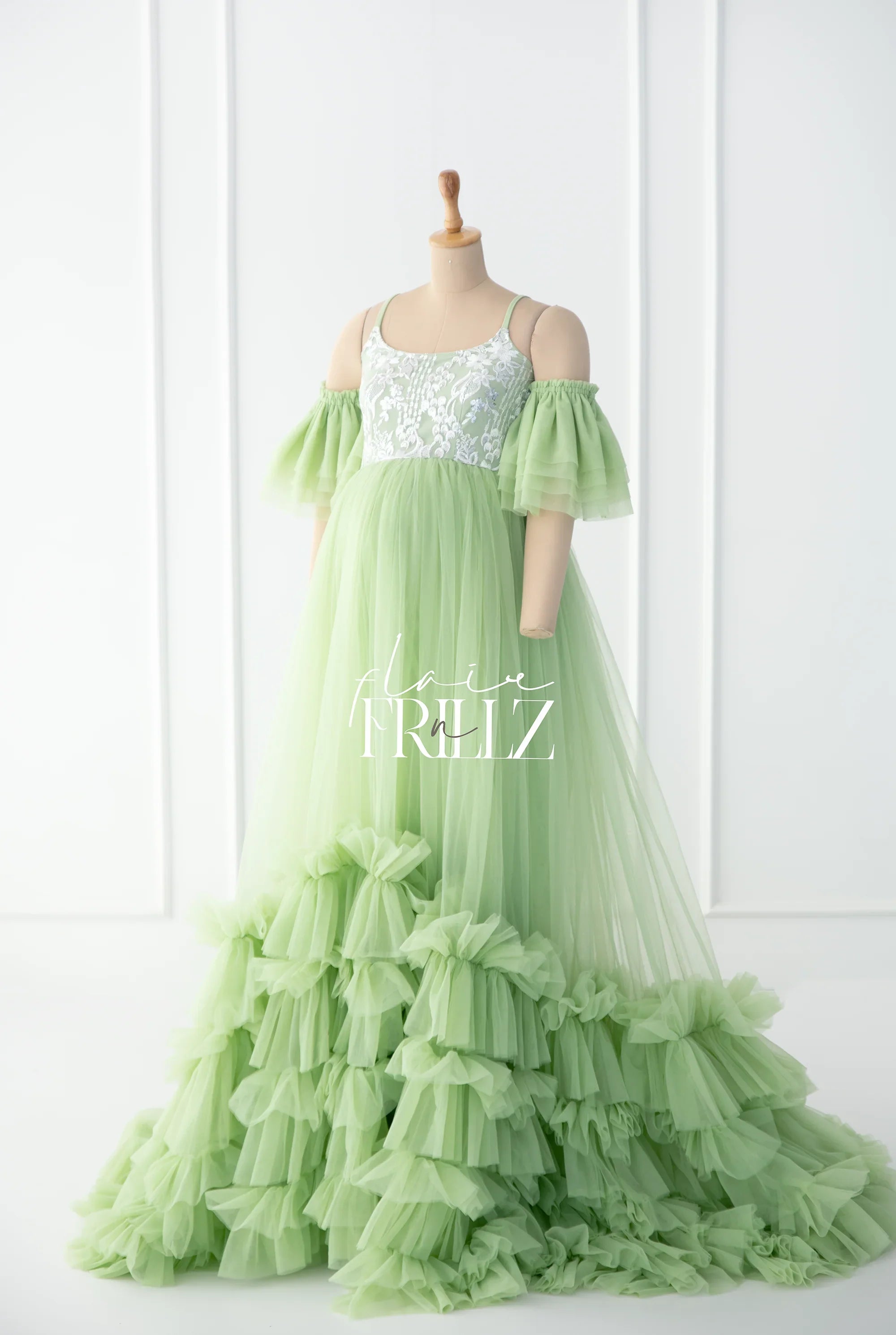 Light green maternity gown with ruffled tulle skirt and off-shoulder puff sleeves