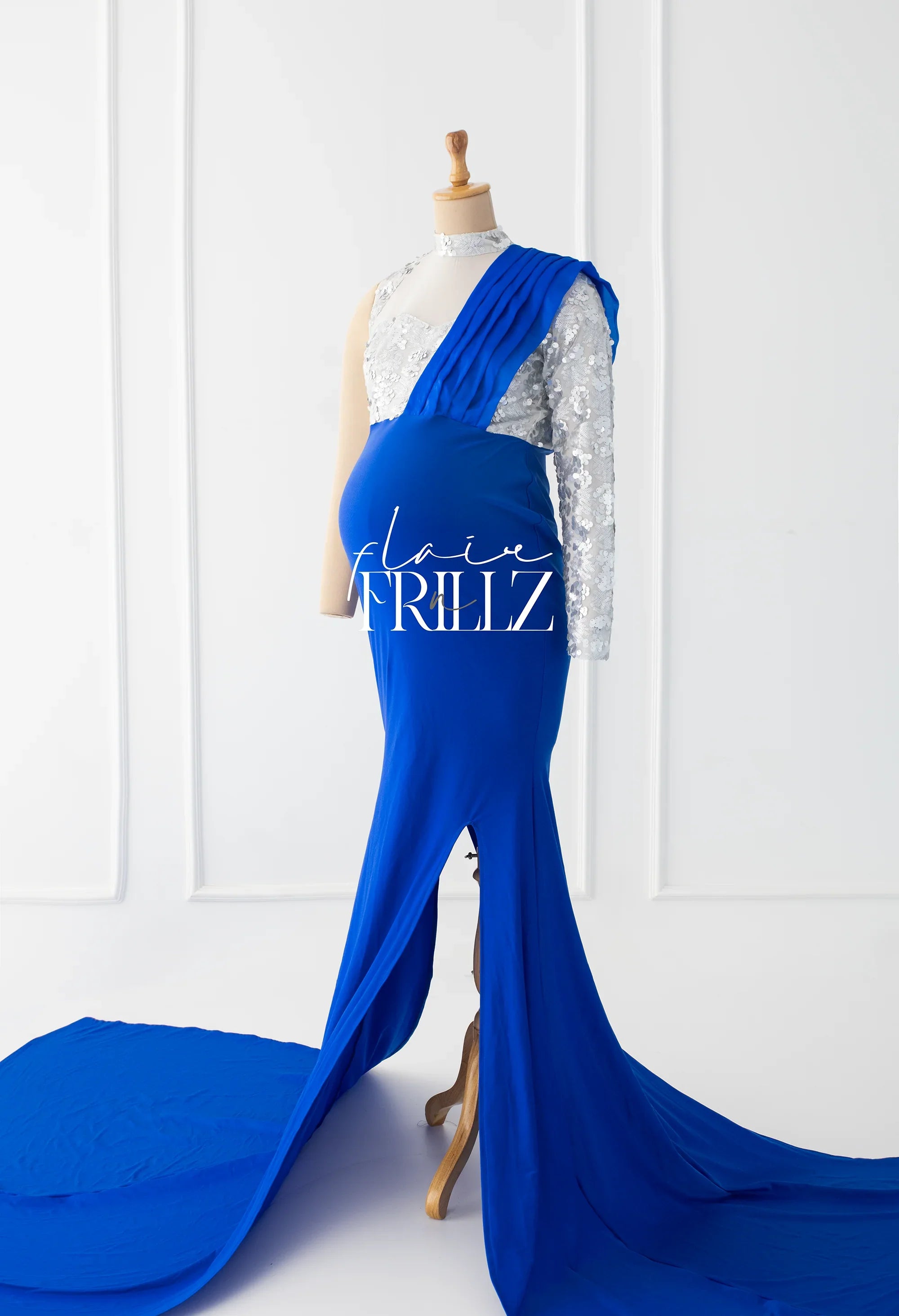 Royal blue maternity gown with sequin sleeve and draped train on mannequin