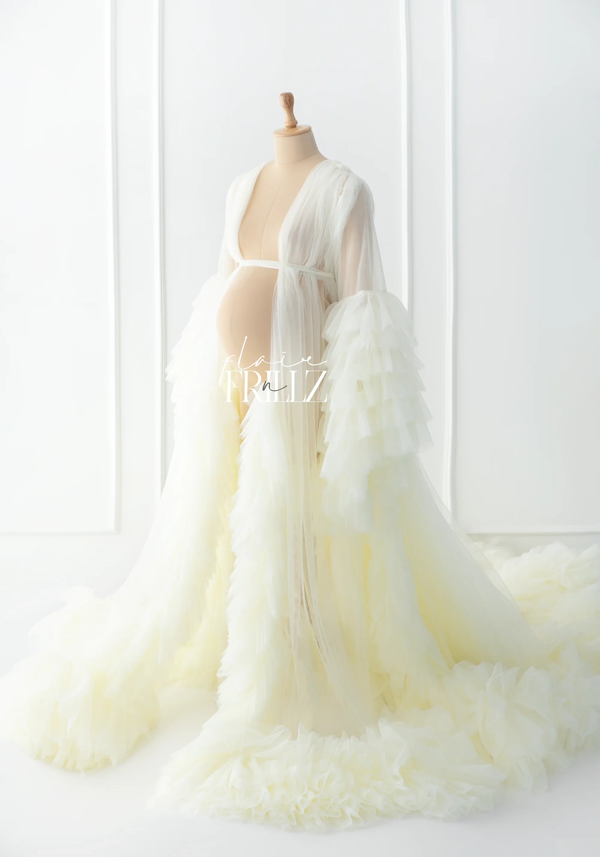 Sheer ivory maternity robe gown with layered ruffle sleeves and long train on mannequin