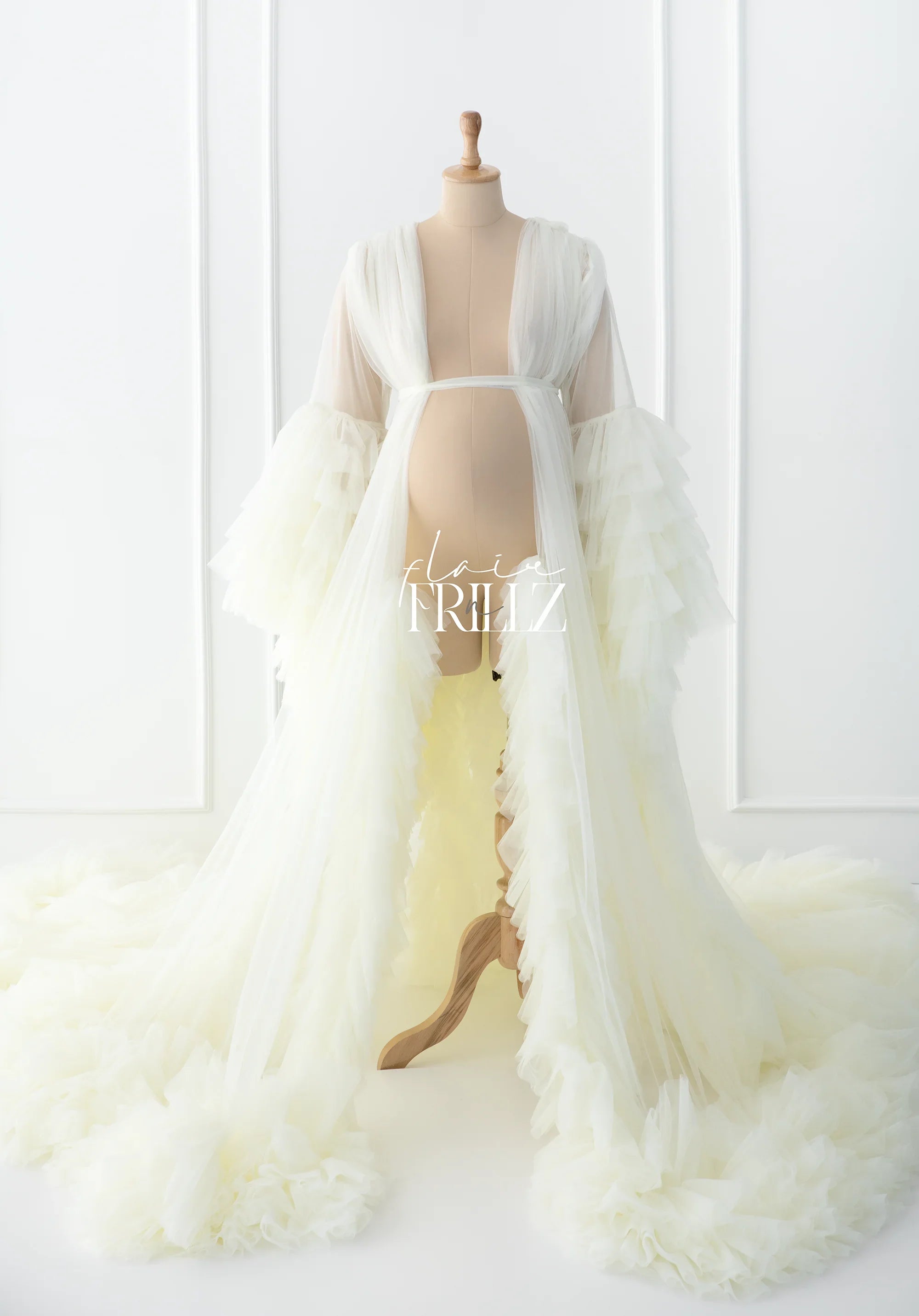 Ivory tulle maternity robe gown with long ruffled sleeves and dramatic train on mannequin