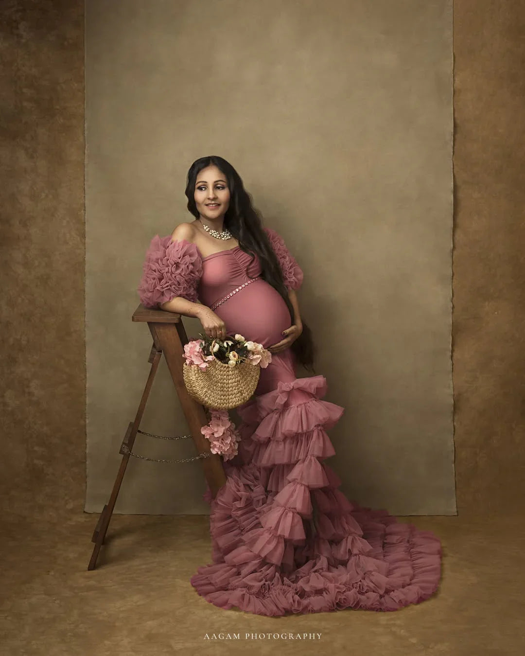 Ember Pink maternity gown by FlairNFrillz featuring a flowing design, perfect for expecting mothers, shown on a model.