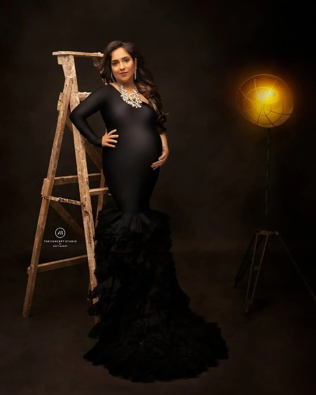 Rumi black maternity gown by FlairNFrillz, flowing fabric, off-shoulder design, perfect for maternity wear and special occasions.