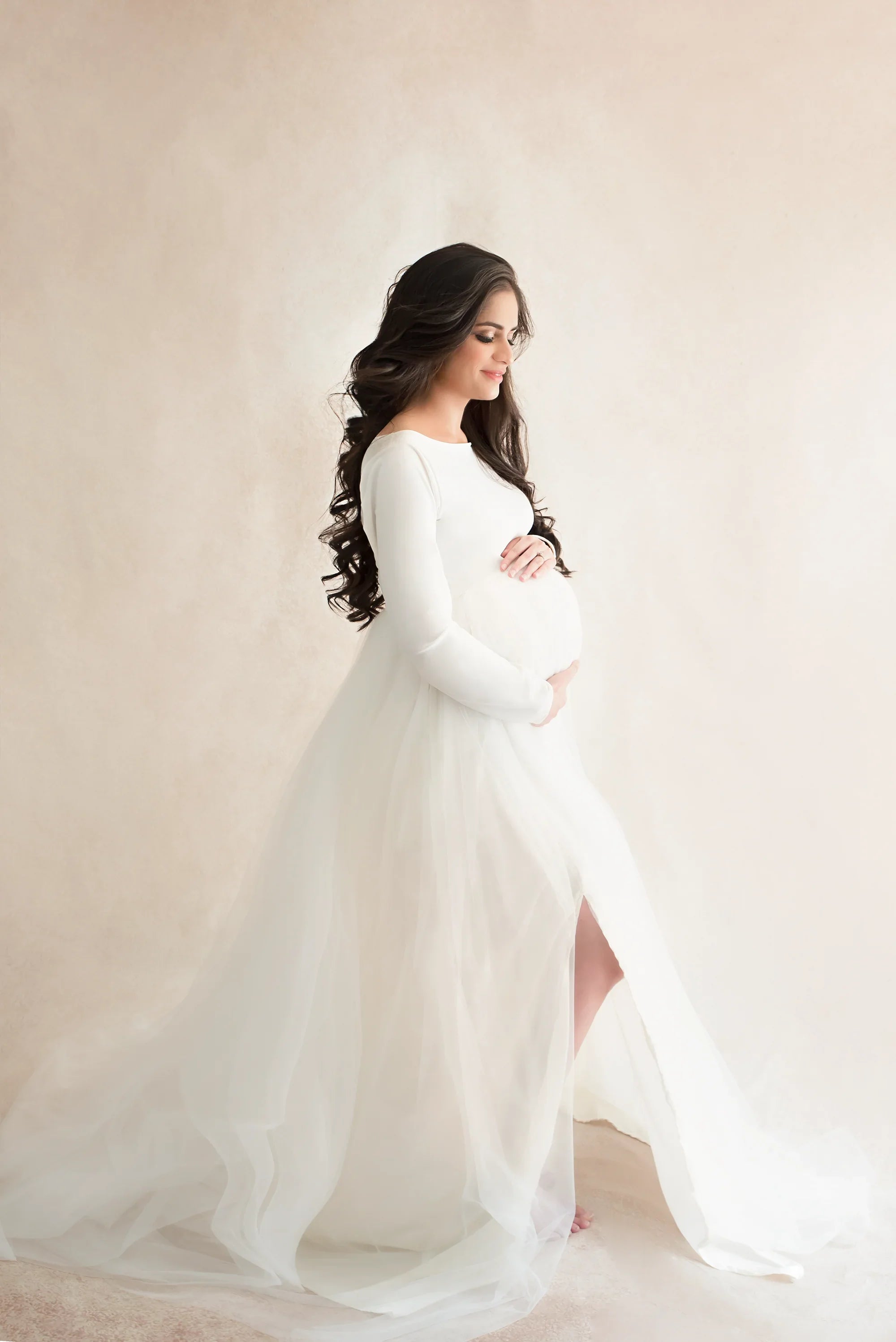 White maternity gown by FlairNFrillz featuring flowing fabric and elegant design, perfect for expecting mothers.