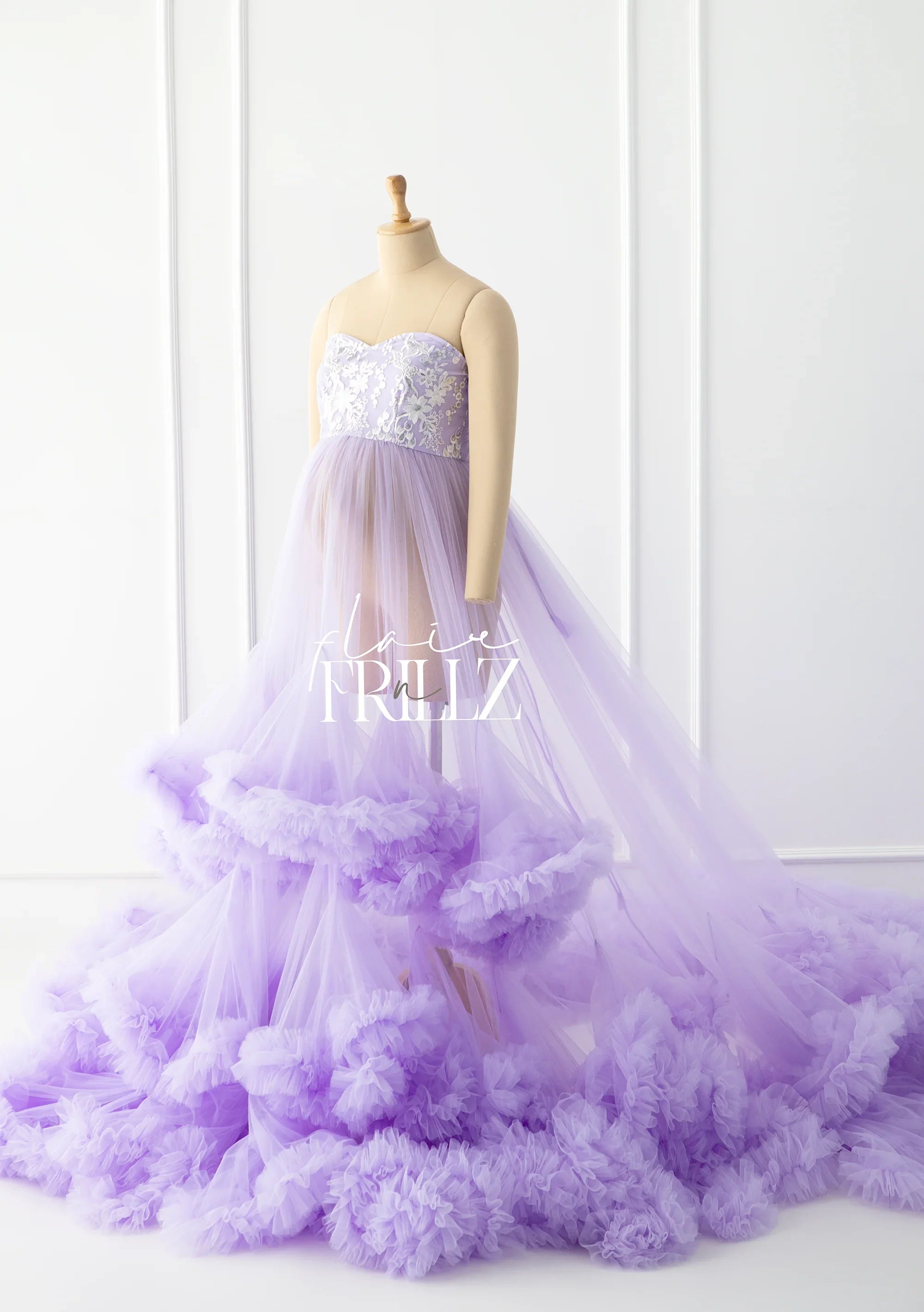 Lavender maternity gown with lace bodice and layered tulle ruffle skirt on mannequin