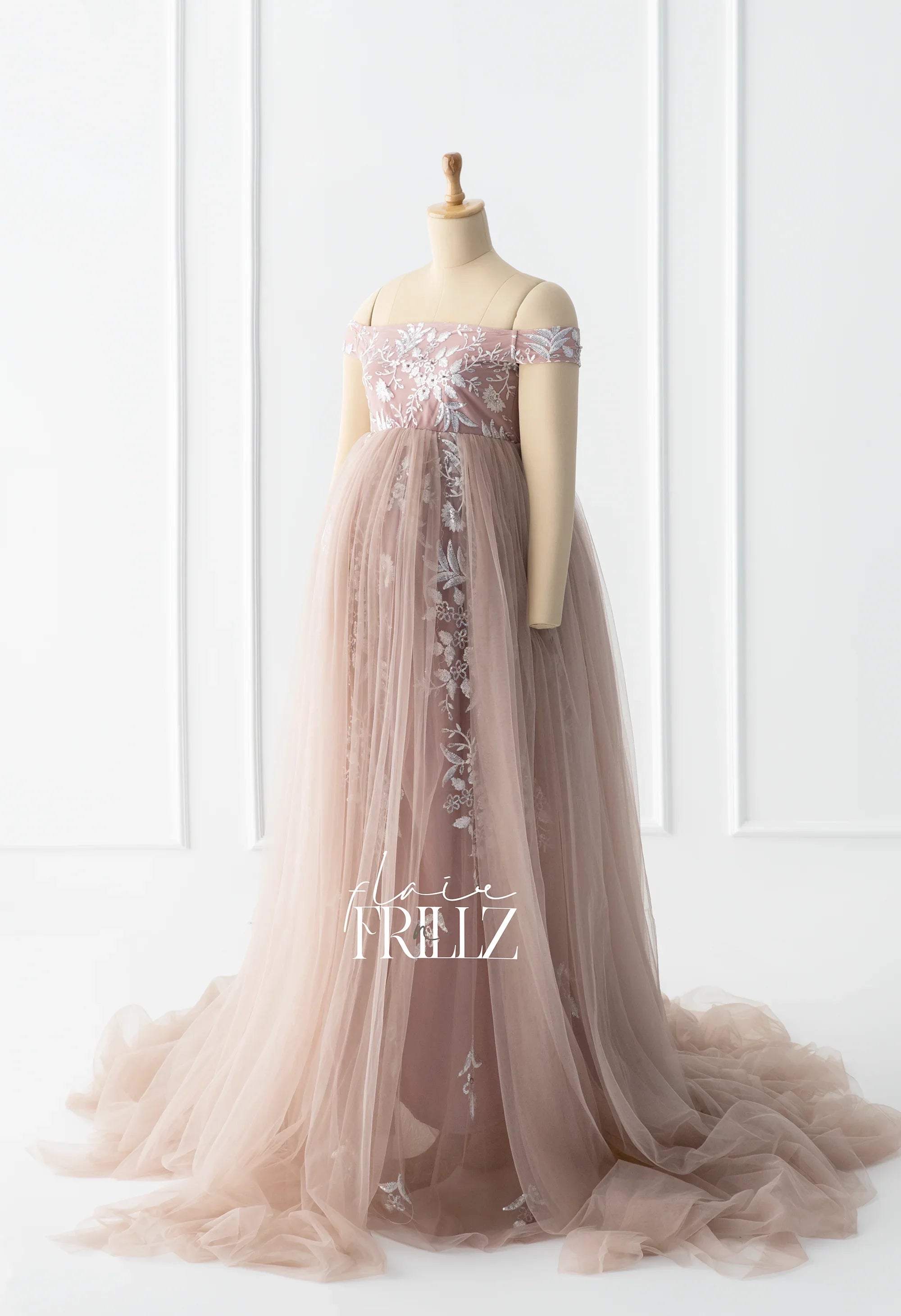 Dusty pink off-shoulder maternity gown with floral embroidery and flowing tulle skirt