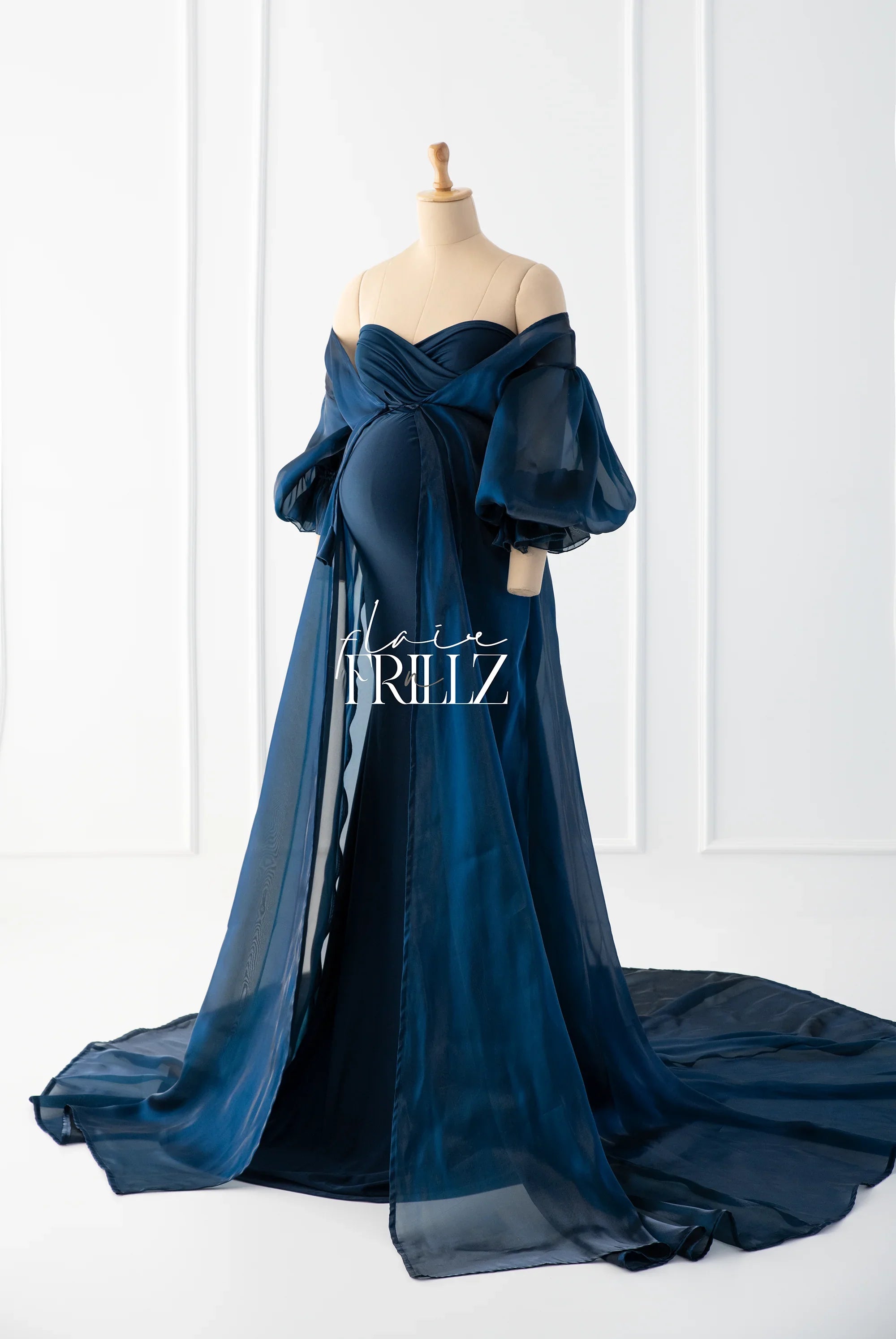 Elegant navy blue off-shoulder maternity gown with sheer puff sleeves and flowing train