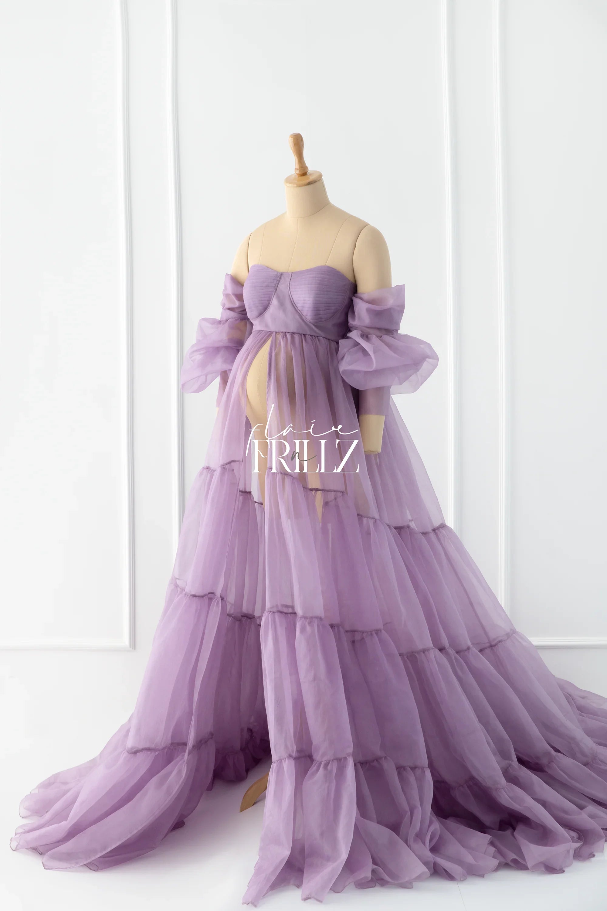 Lavender off-shoulder maternity gown with sheer layered tulle on a mannequin
