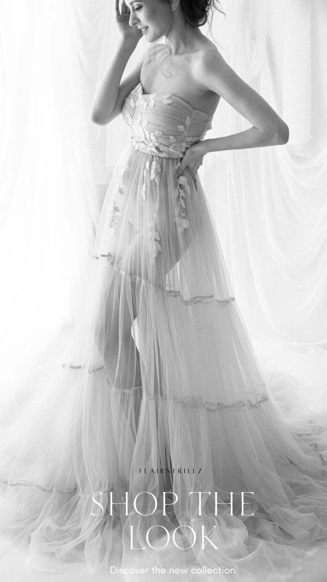 Elegant maternity gown with floral applique details, sheer layers, and strapless design