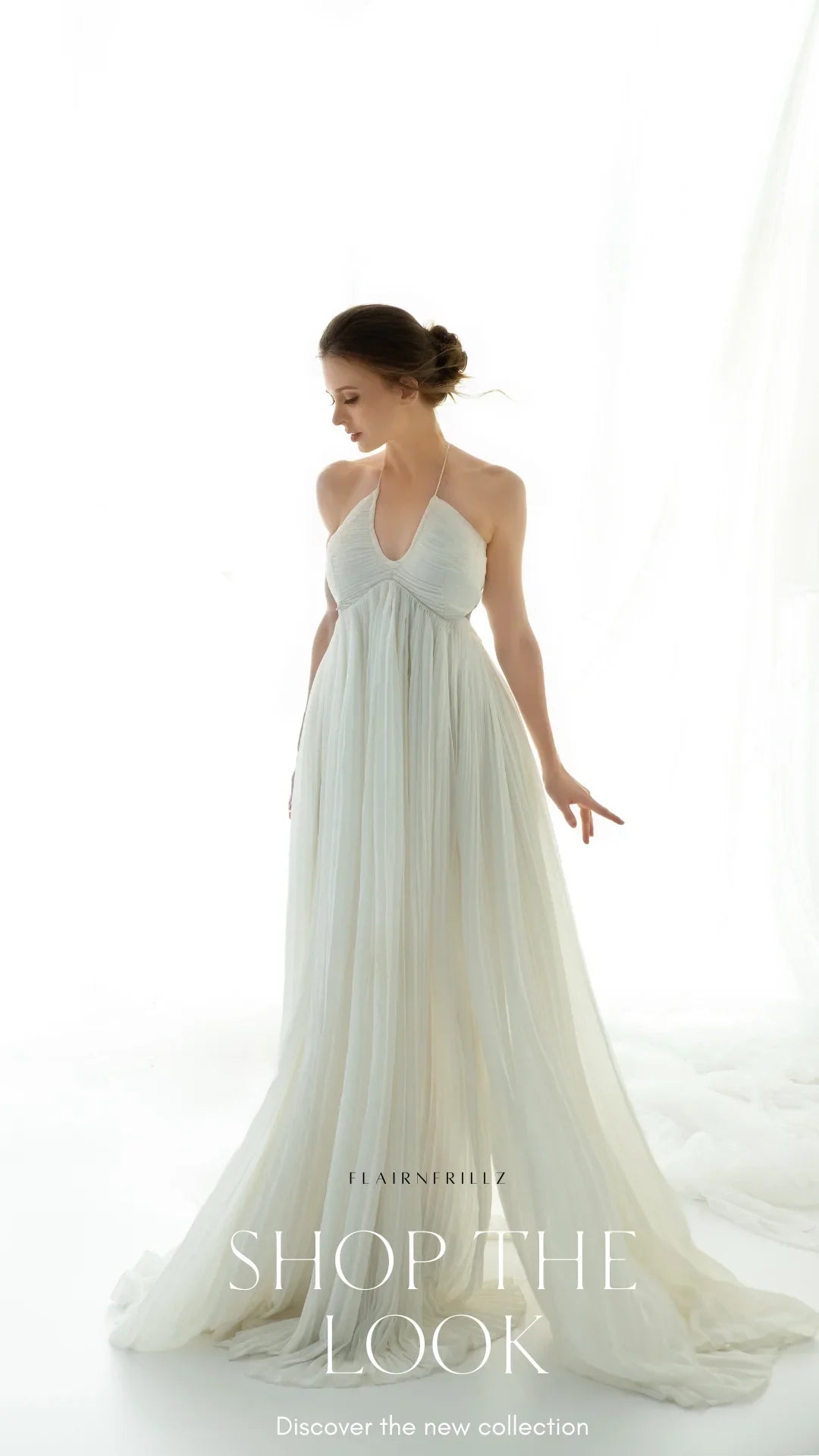 Pregnant woman in elegant white maternity gown on a bright, minimal background