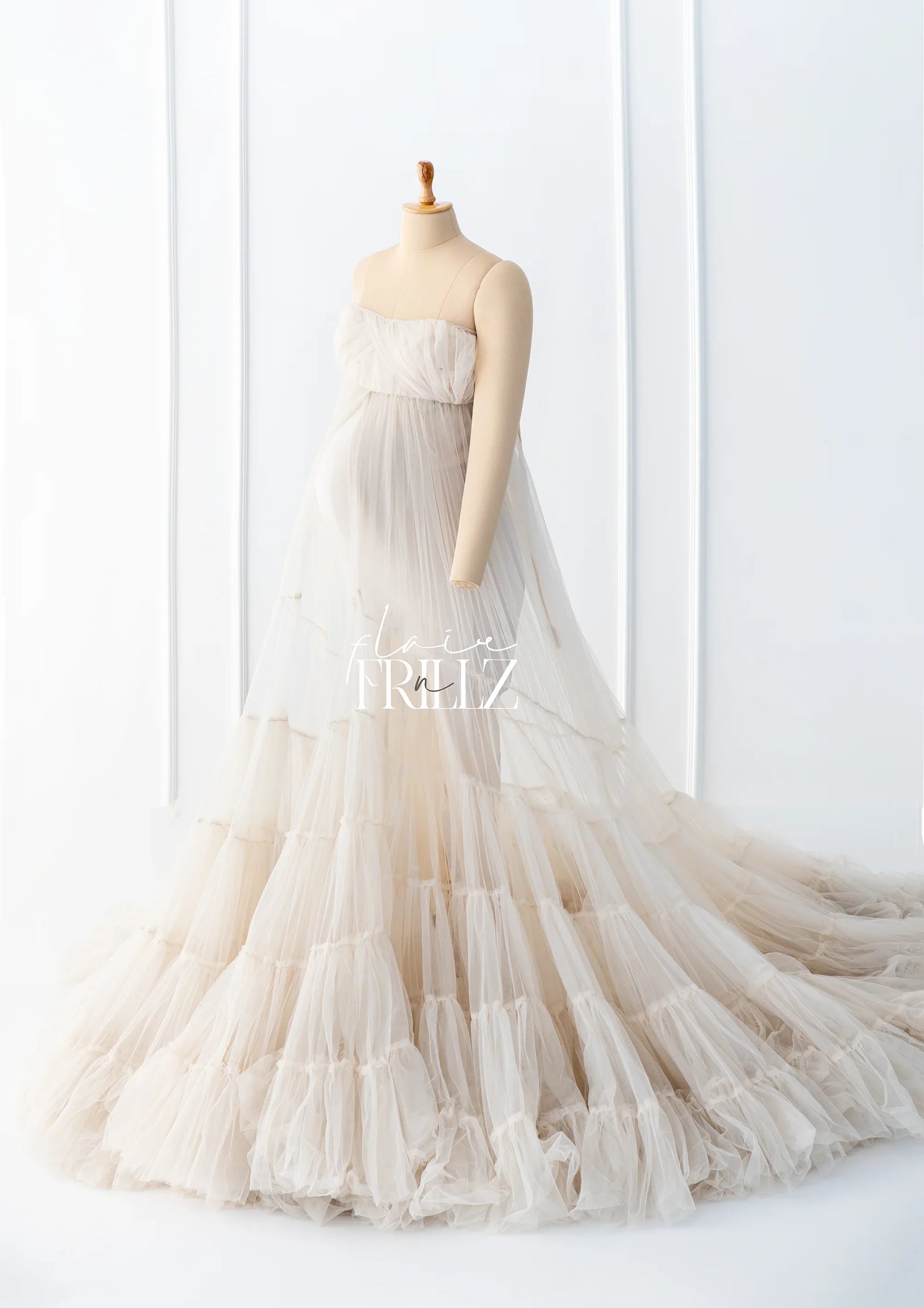 Ivory strapless maternity gown with layered tulle, displayed on a mannequin