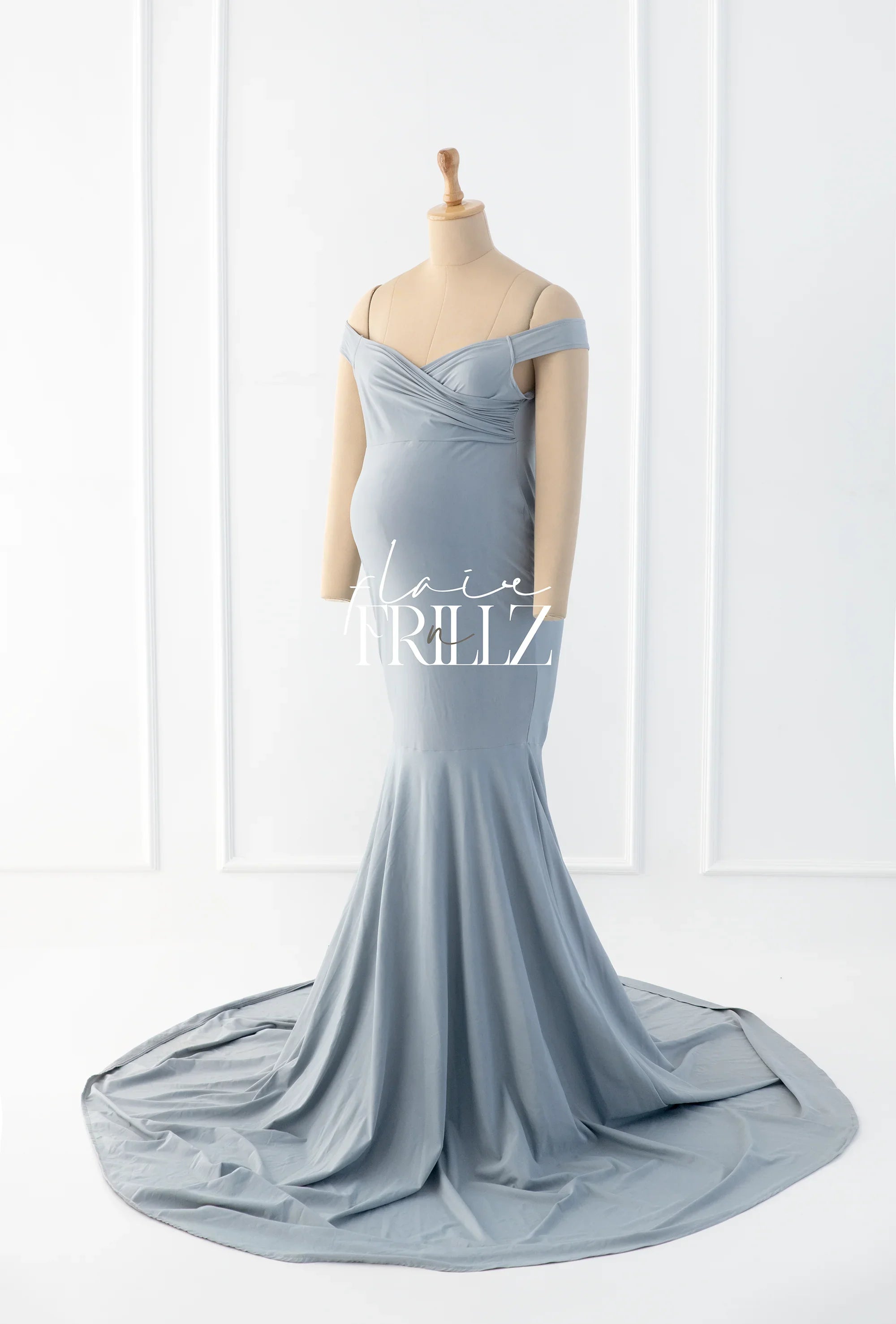 Light blue off-shoulder maternity gown with a fitted bodice and flowing train on mannequin
