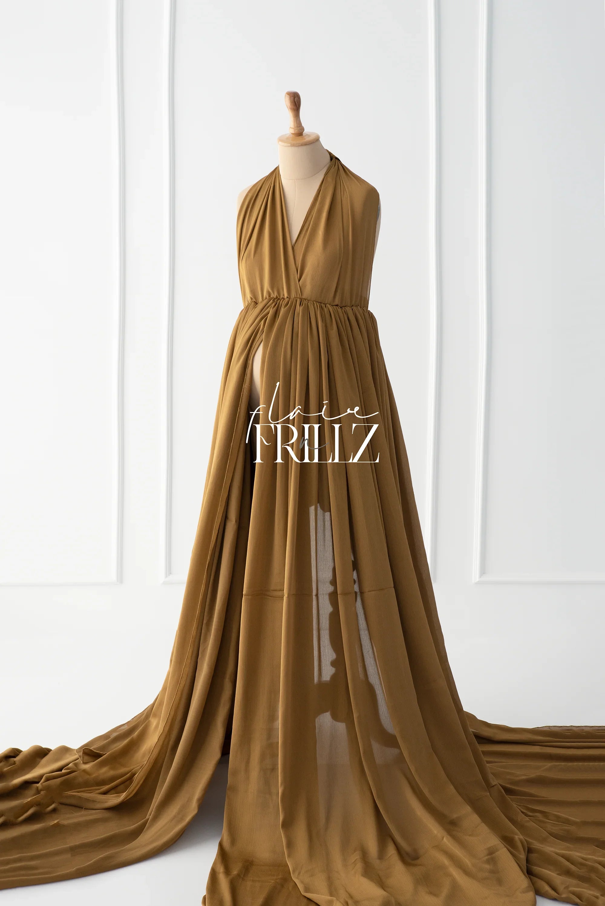 Brown silky maternity gown with flowing train displayed on mannequin in studio setting