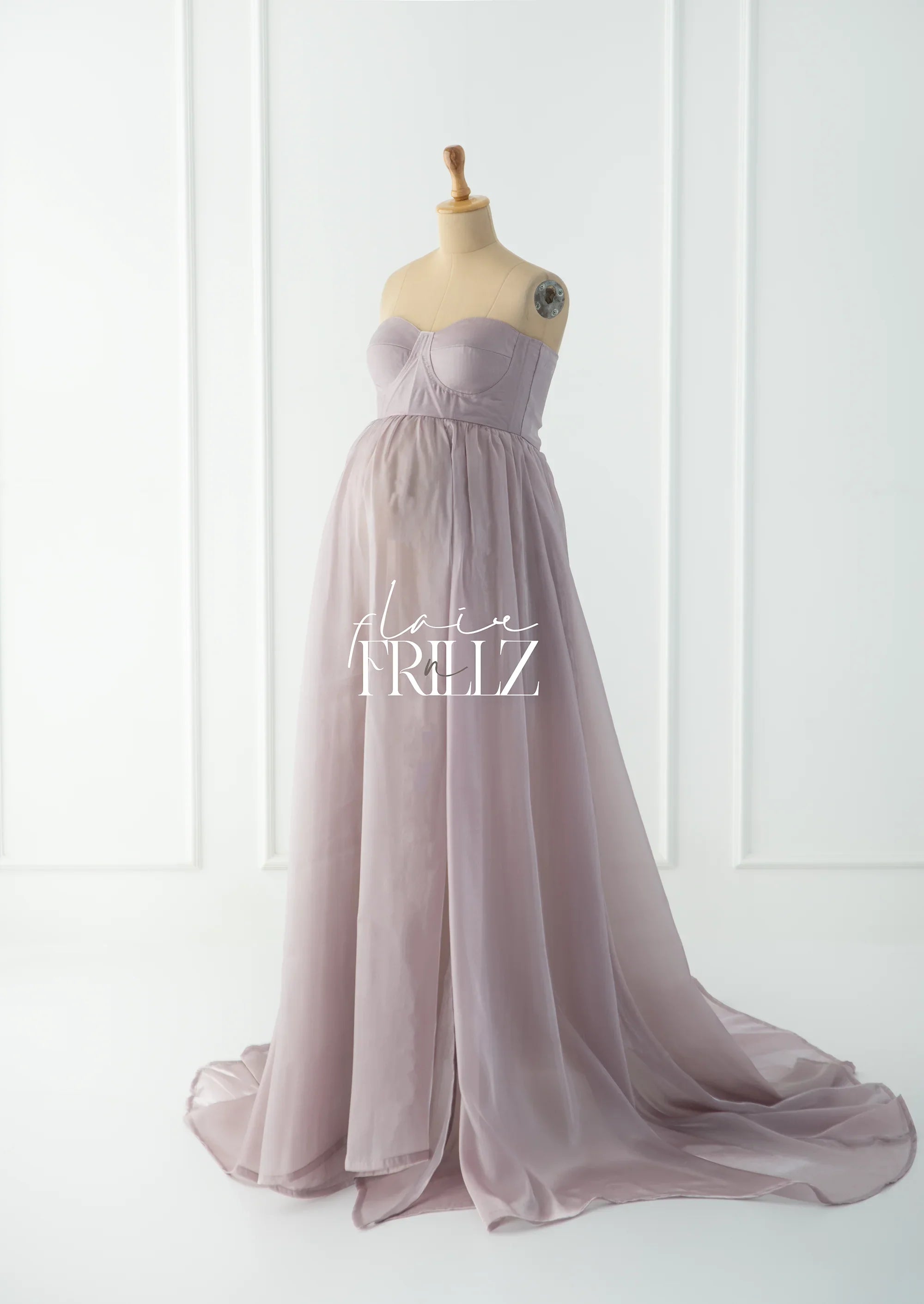 strapless lavender maternity gown with flowing chiffon skirt on mannequin in bright studio