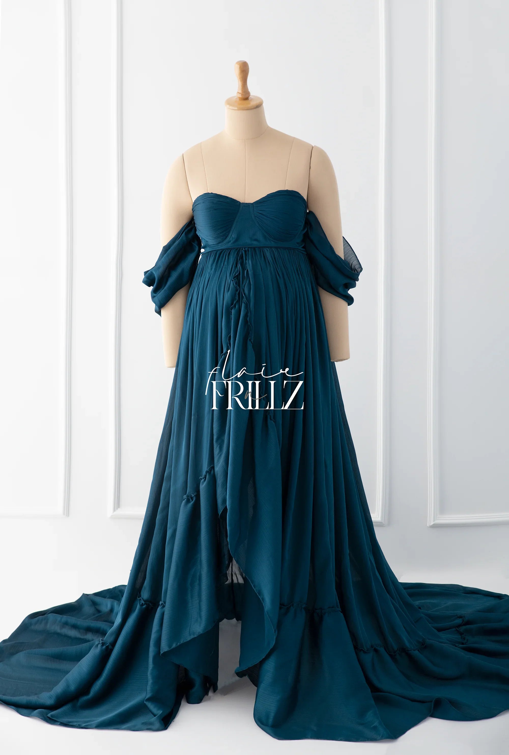 Teal off-shoulder maternity gown with flowing skirt and sweetheart neckline on mannequin