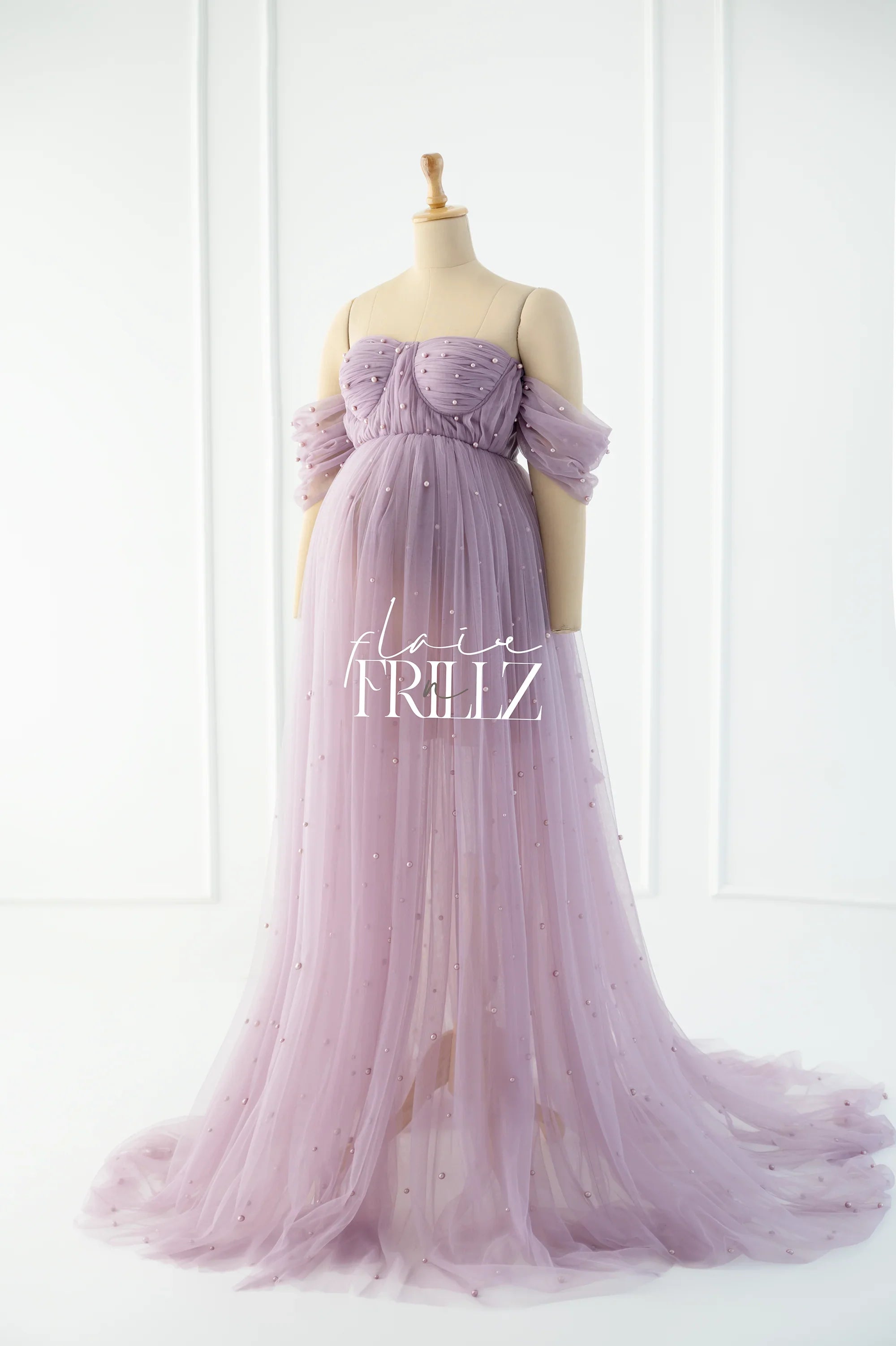 Lilac off-shoulder tulle maternity gown with pearl embellishments on a mannequin