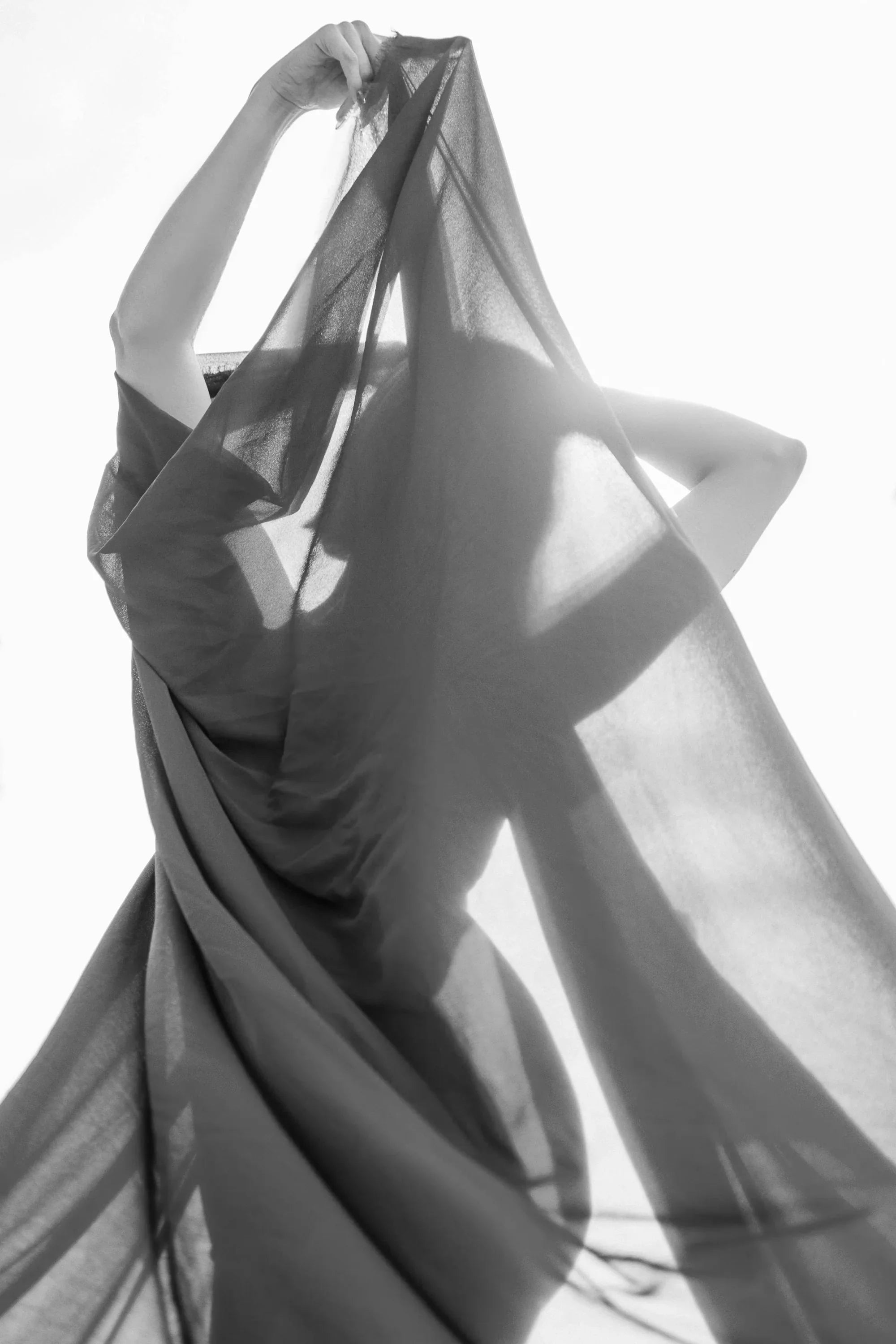 Elegant maternity gown with flowing sheer fabric, designed for comfort and style during pregnancy.