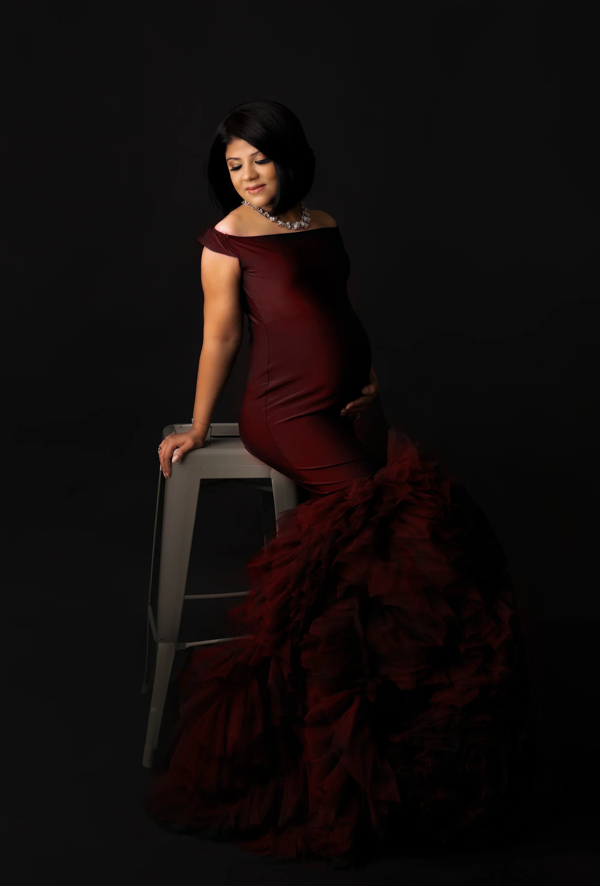 Maroon maternity gown from FlairNFrillz with elegant fabric and flowing design, perfect for expecting mothers.