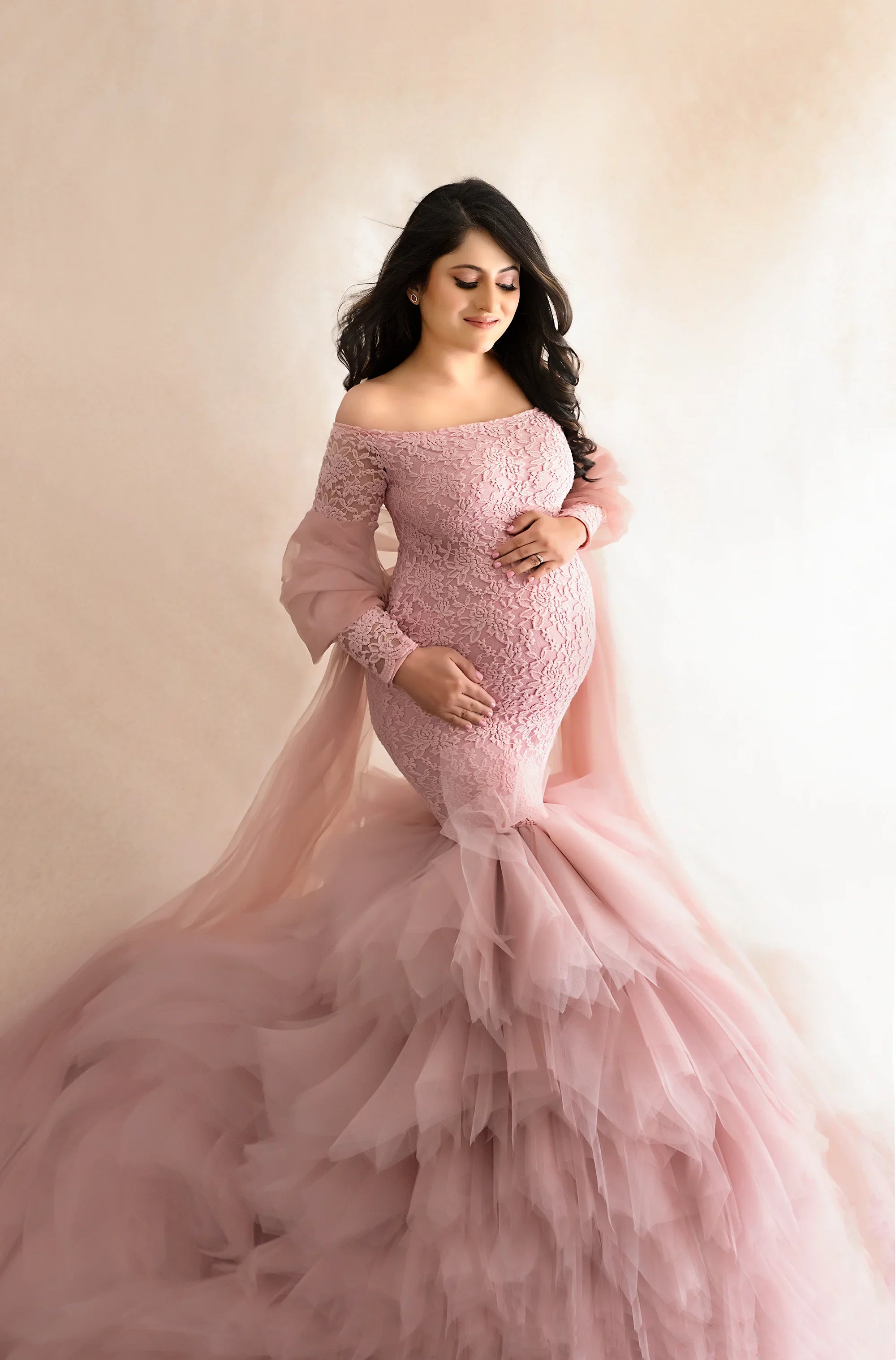 FlairNFrillz Alexa Pink Maternity Dress displayed on a hanger showing flowing fabric and elegant design.