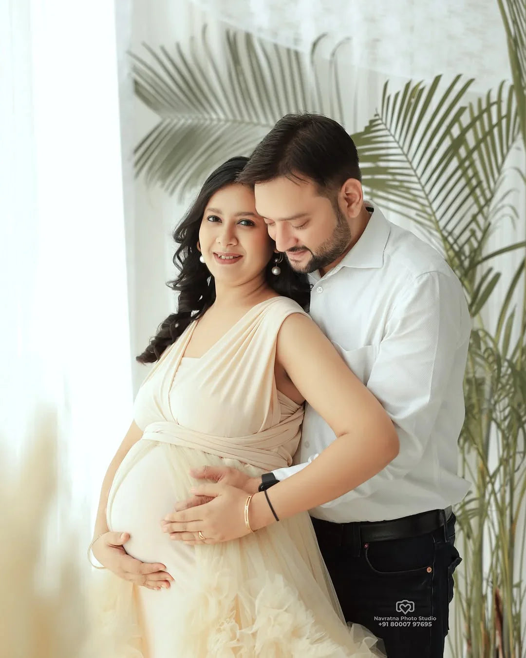 A FlairNFrillz Aza Ivory Convertible Maternity Gown displayed on a model, showcasing elegant fabric and versatile style.