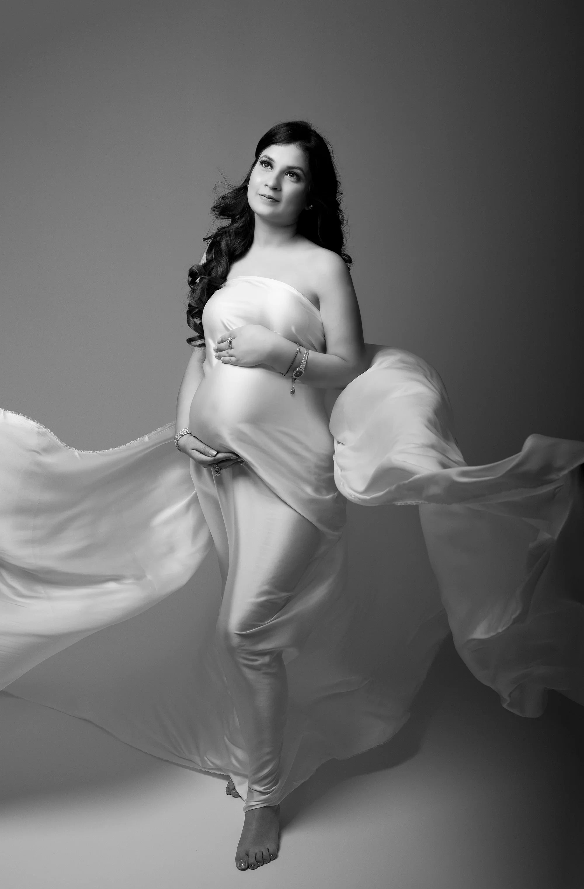 Noah white maternity dress by FlairNFrillz featuring elegant drape design, perfect for expecting mothers, shown on a hanger.