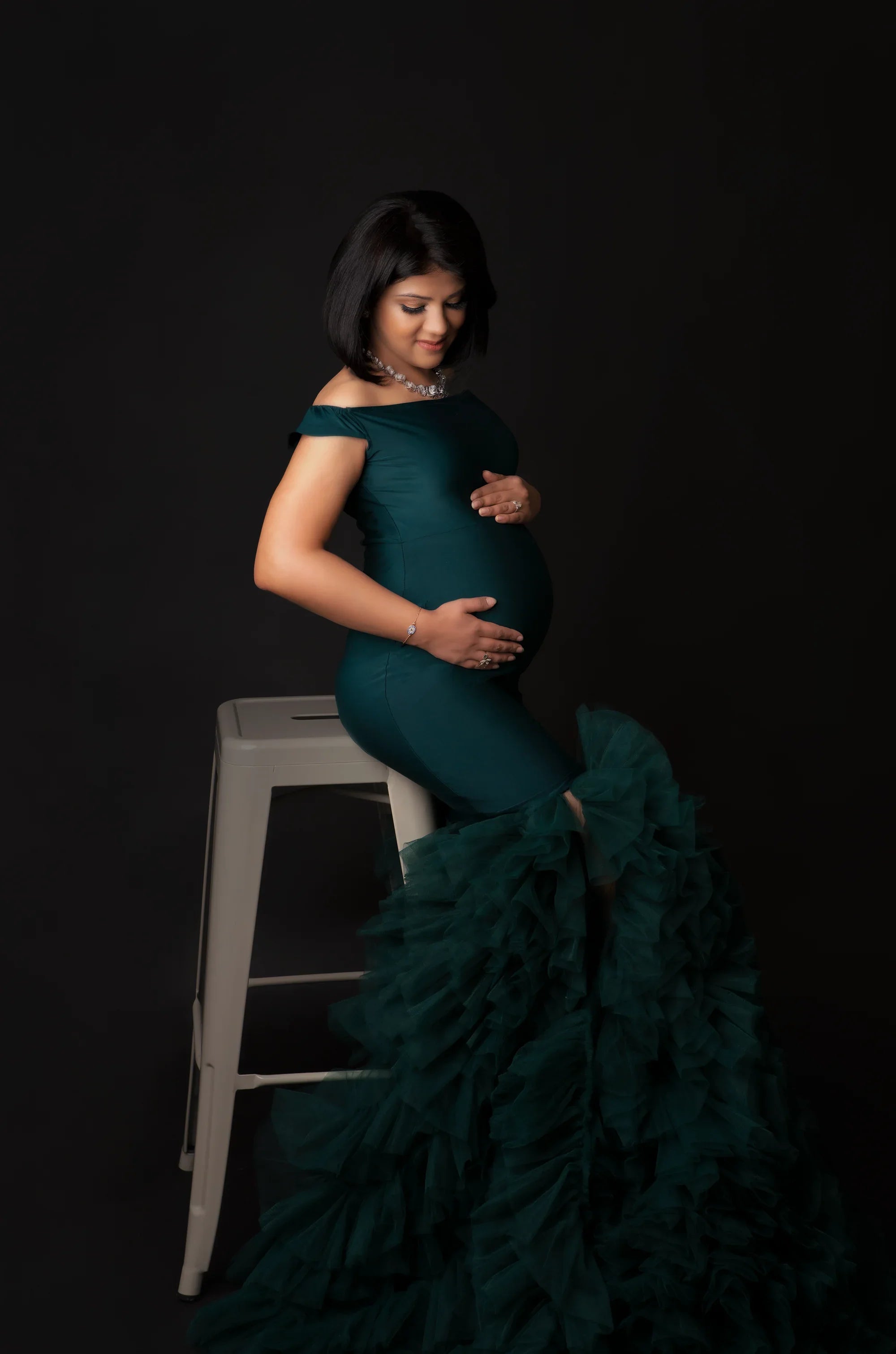 FlairNFrillz Inaya green maternity gown with elegant flowing fabric, perfect for expecting mothers attending special occasions.