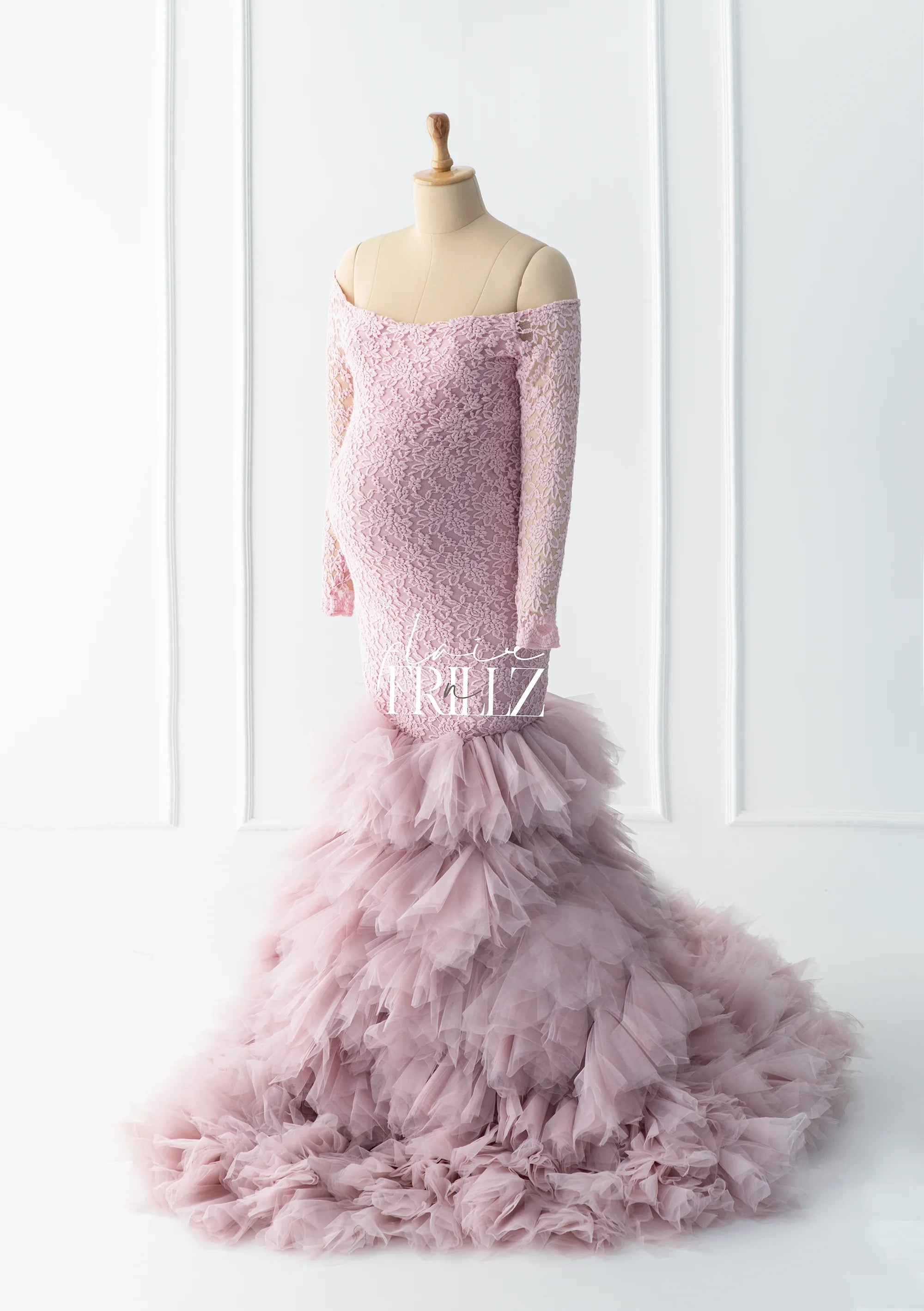 Pink lace off-shoulder maternity gown with ruffled tulle mermaid skirt on mannequin