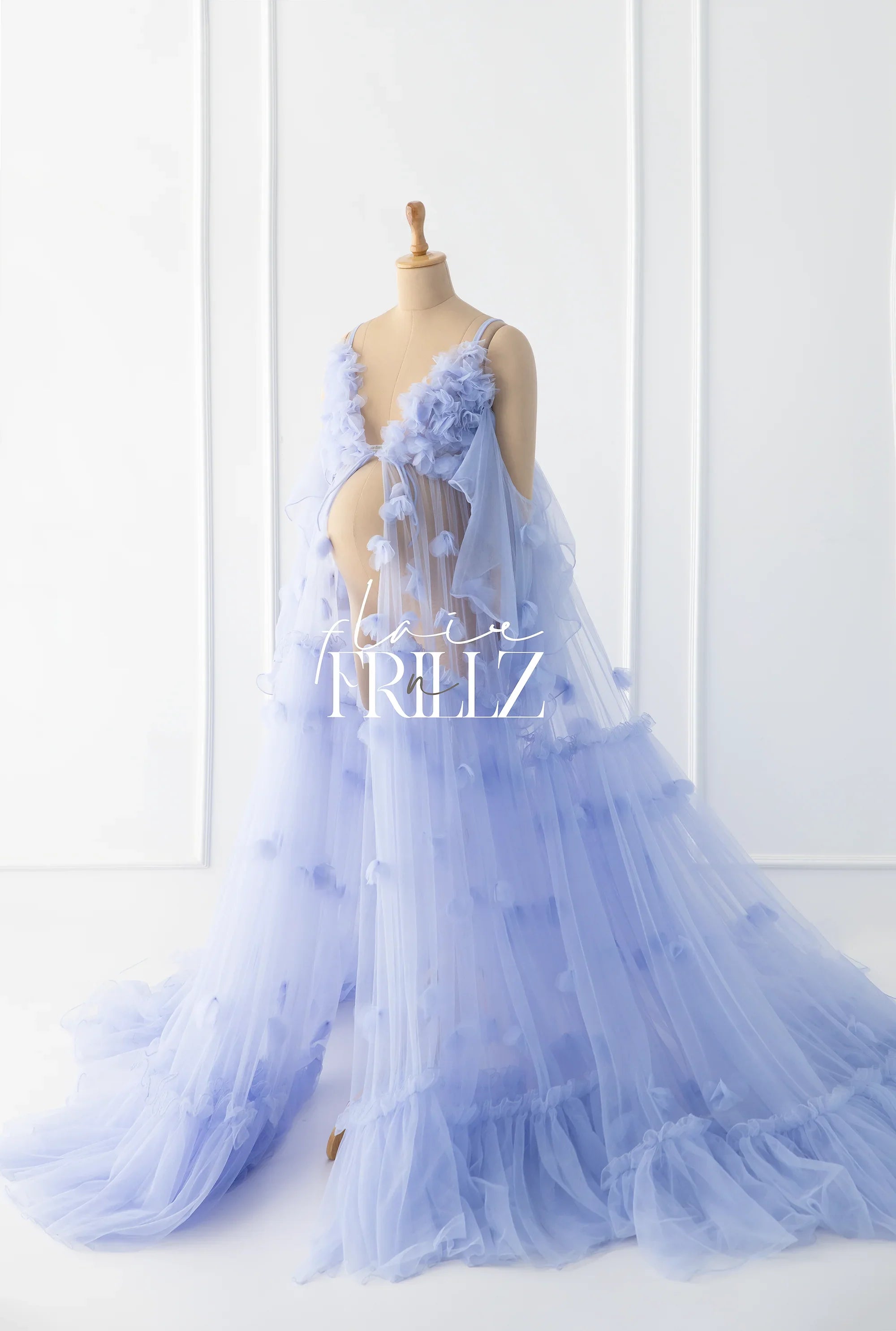 Flowy lavender maternity gown with floral tulle details on a dress form, studio background