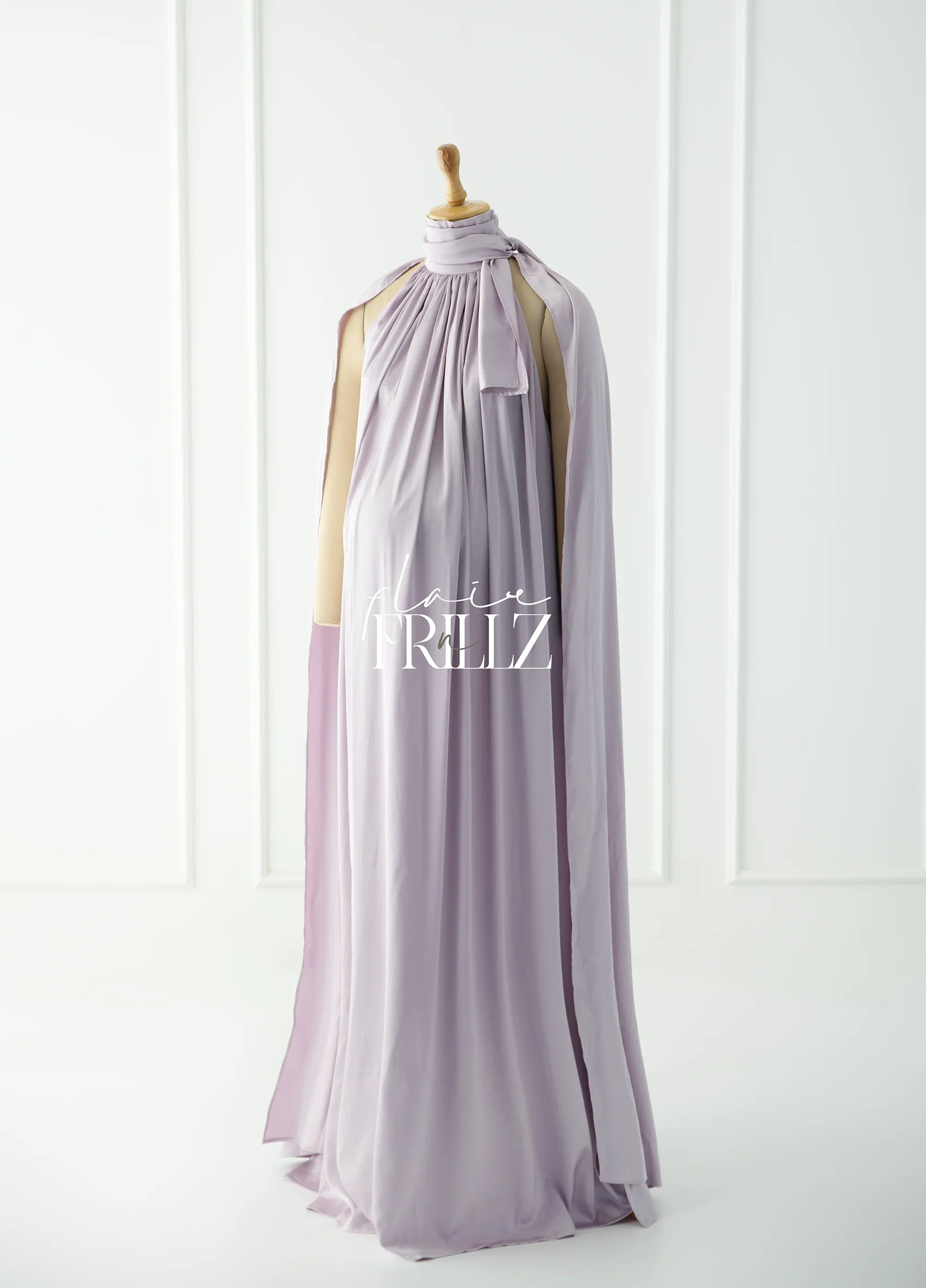 Lilac sleeveless maternity gown with a high neck and bow, displayed on mannequin