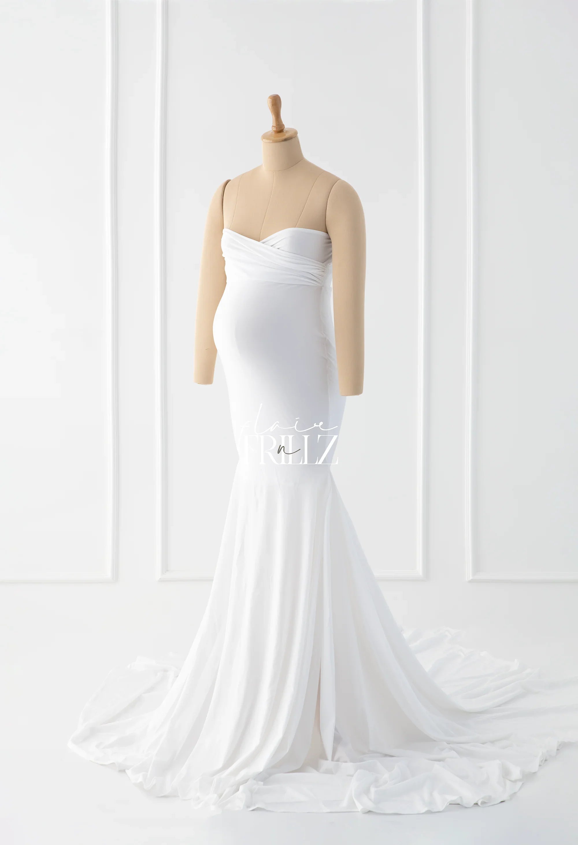 White strapless maternity gown with ruched bodice and flowing mermaid skirt on mannequin