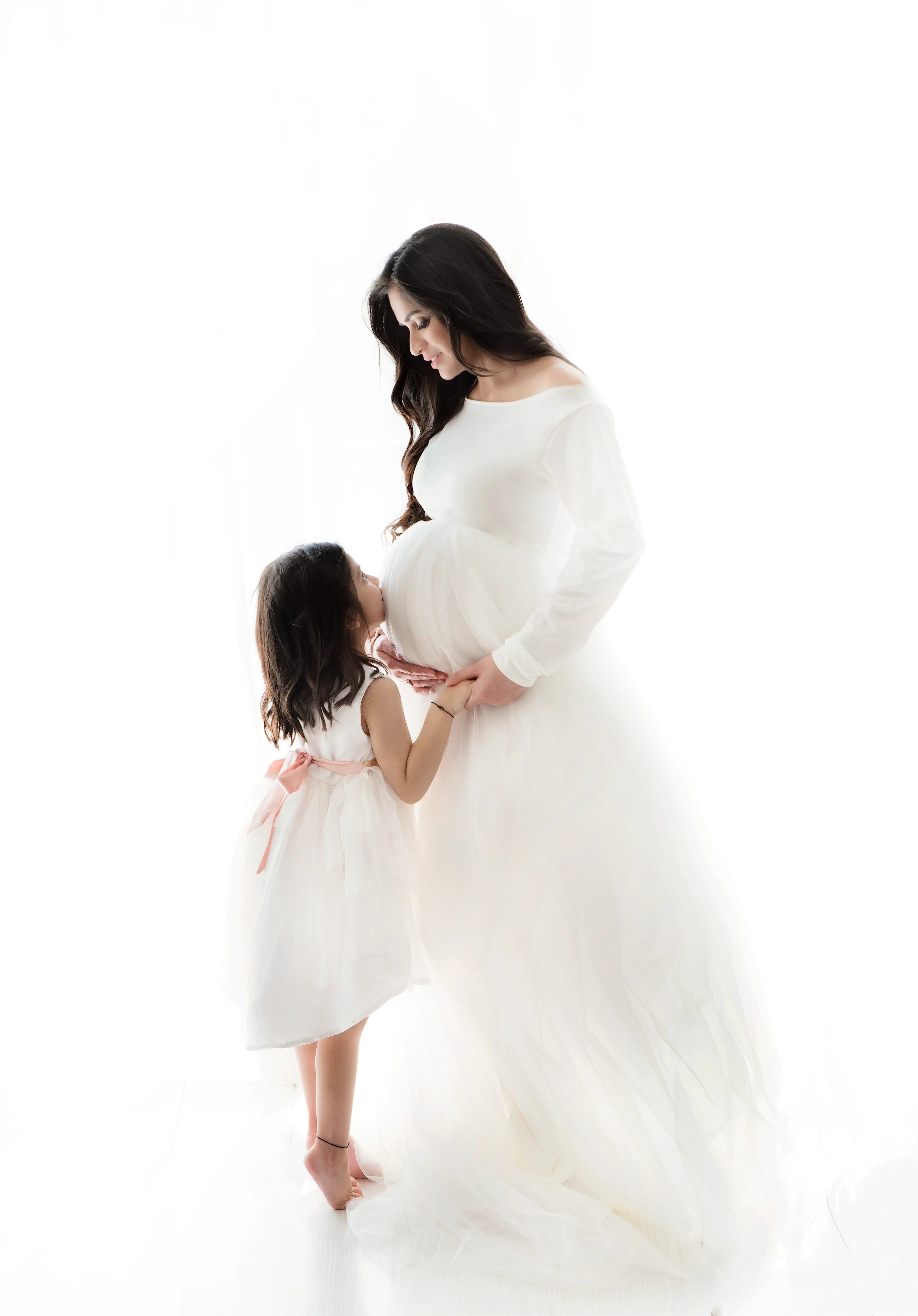 FlairNFrillz Indie White Maternity Gown with flowing fabric and elegant design, perfect for expecting mothers.