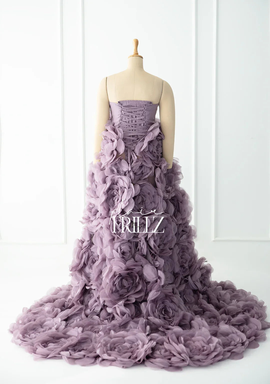 Lavender floral maternity gown with ruffled 3D petals displayed on a mannequin
