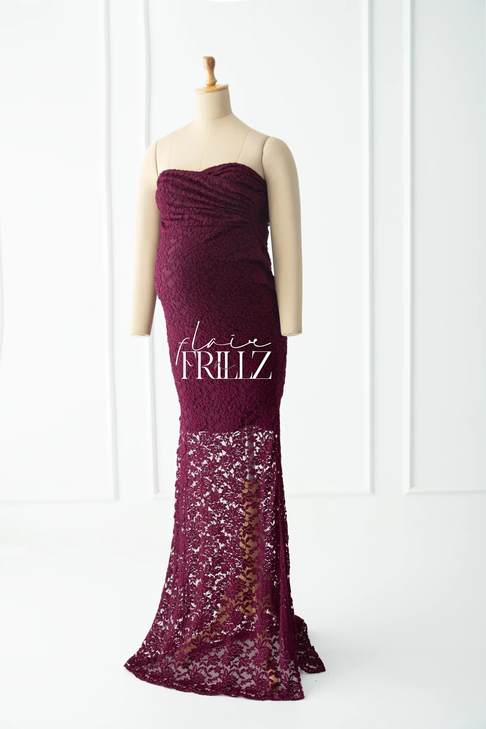 Burgundy strapless lace maternity gown with sheer floral skirt on mannequin