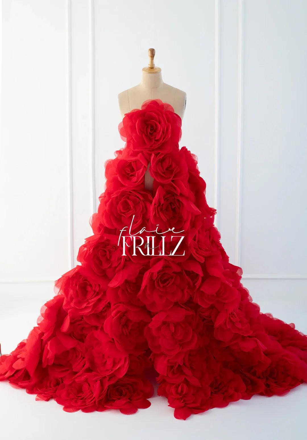 Red floral gown for maternity photoshoot on mannequin in bright studio