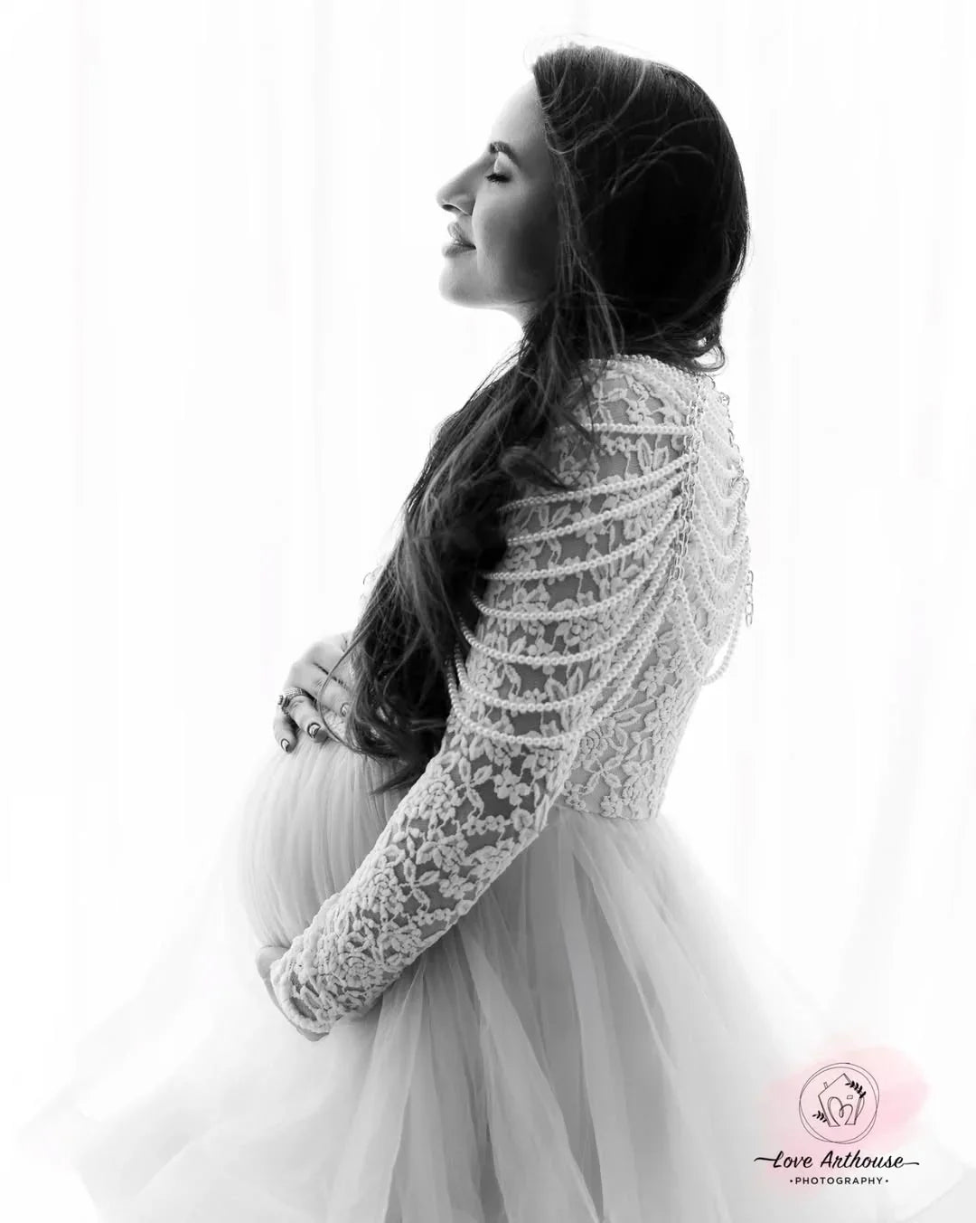 FlairNFrillz Rosa Maternity Gown in soft pink fabric, flowing design with floral details, perfect for expecting mothers.