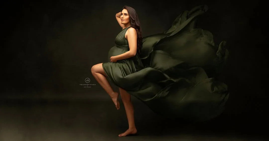 Evie Green maternity gown by FlairNFrillz featuring flowing fabric and elegant design for comfortable maternity wear.