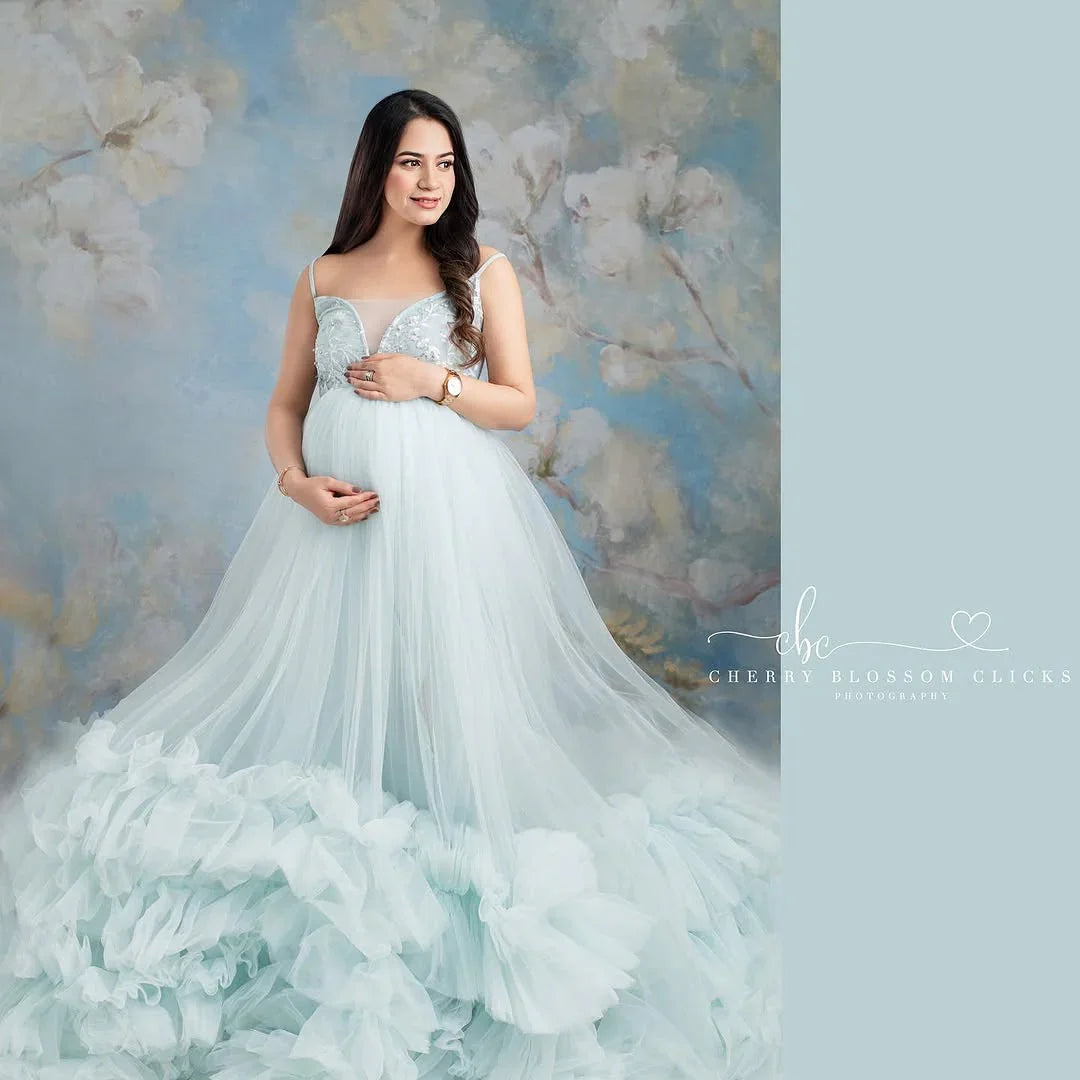 Blue Alia maternity gown by FlairNFrillz, flowing fabric with elegant design, perfect for expecting mothers, shown on a model.