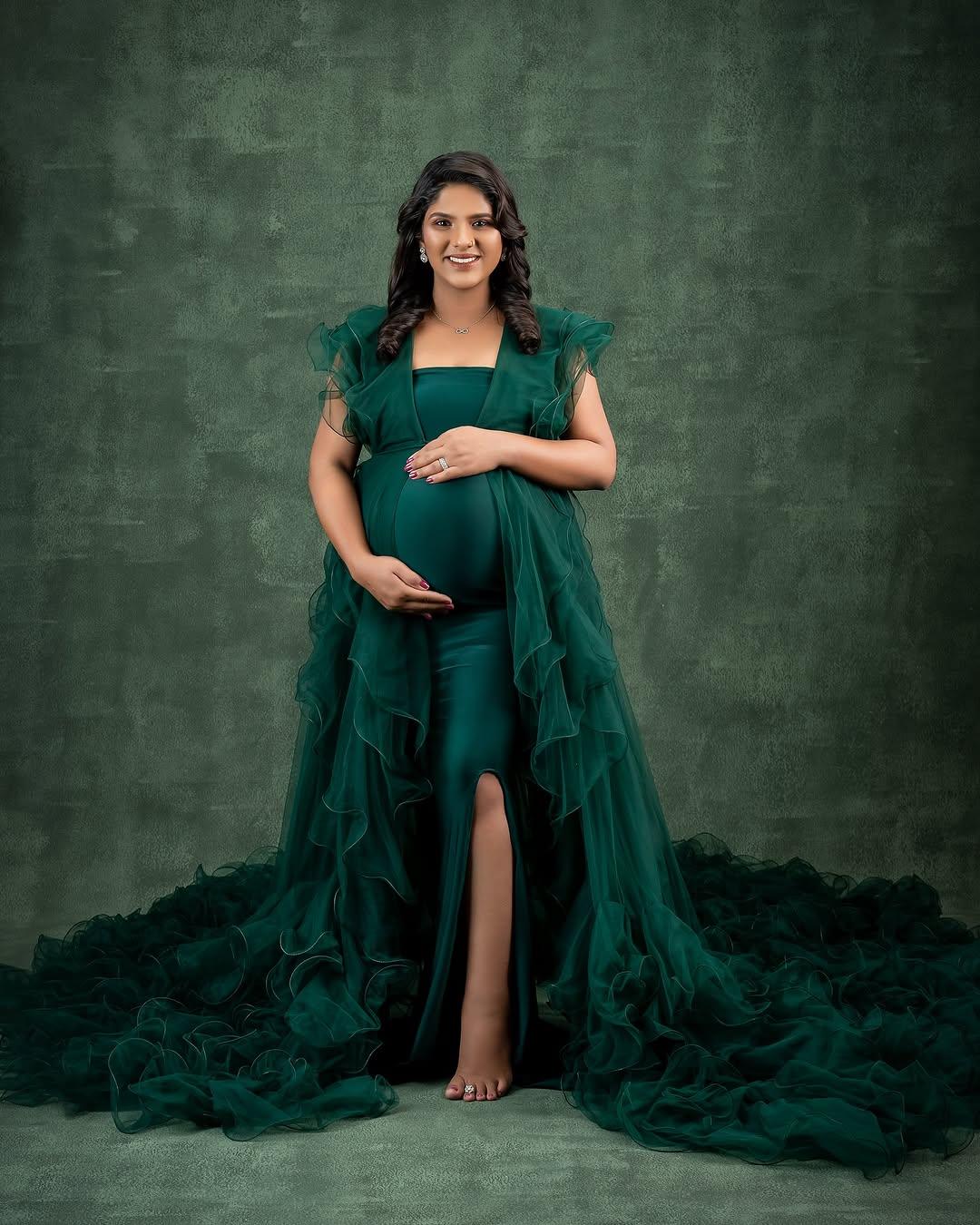 FlairNFrillz Margot Green Maternity Robe Gown with flowing fabric and adjustable waist for comfortable maternity wear.