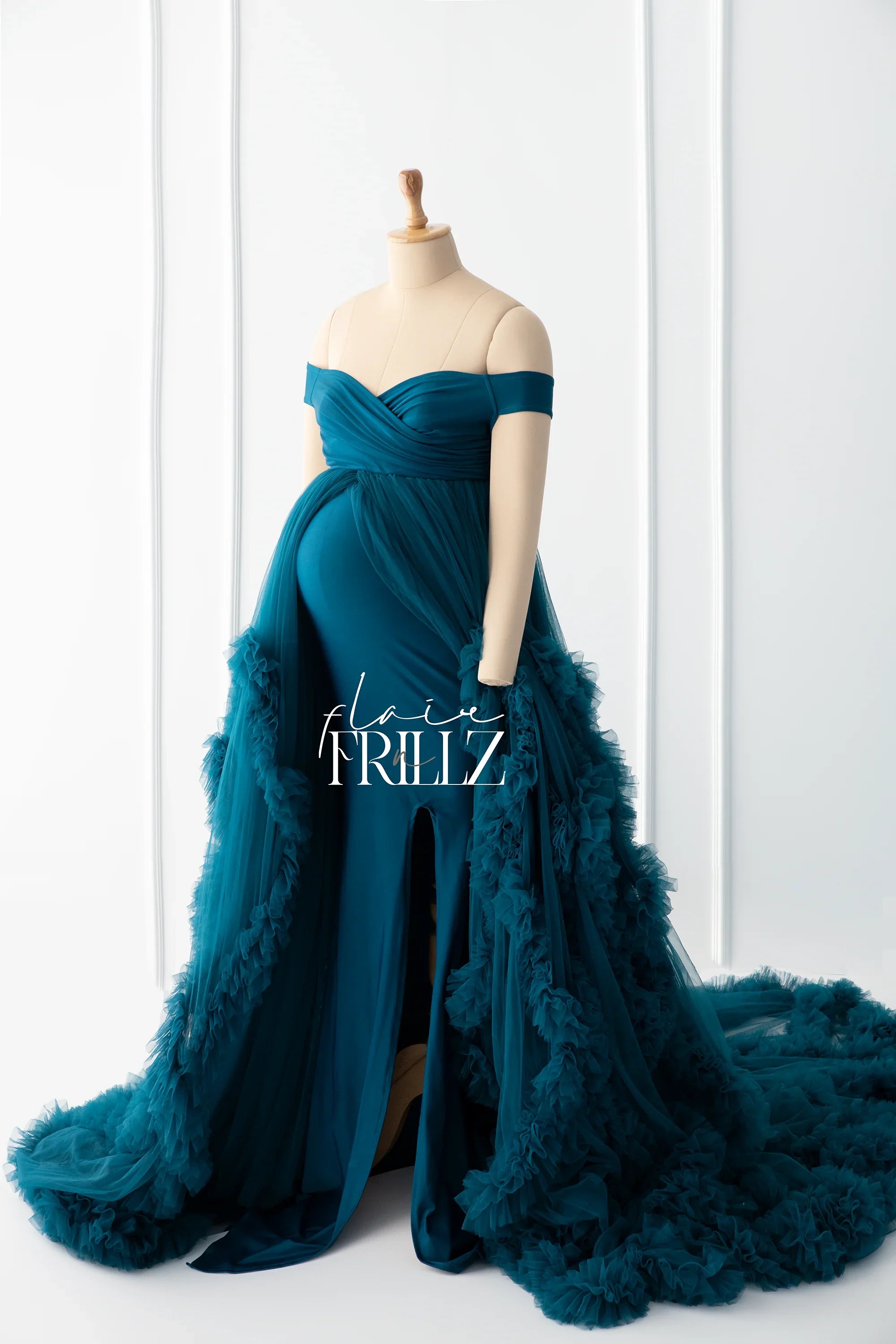 Teal off-shoulder maternity gown with tulle ruffles and front slit on mannequin