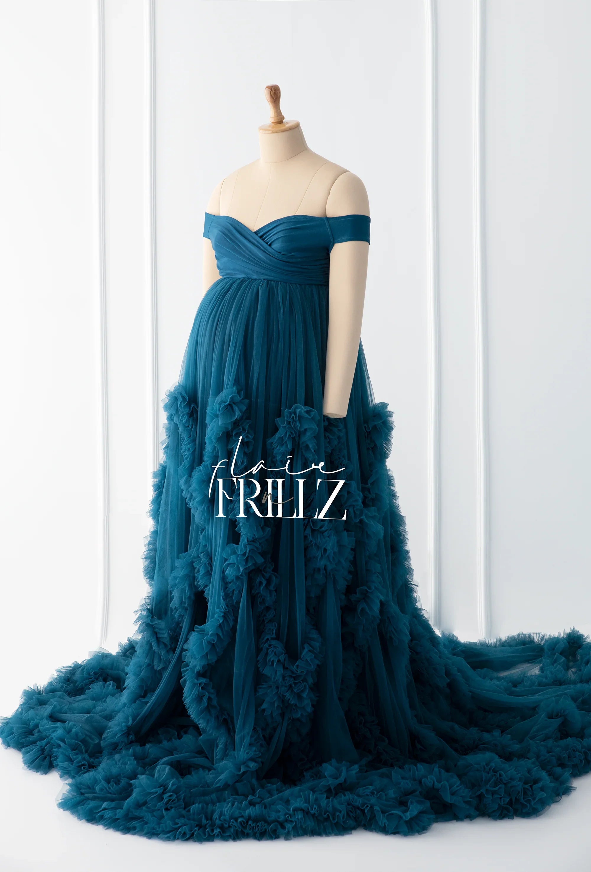 Teal off-shoulder maternity gown with ruffled tulle details on mannequin